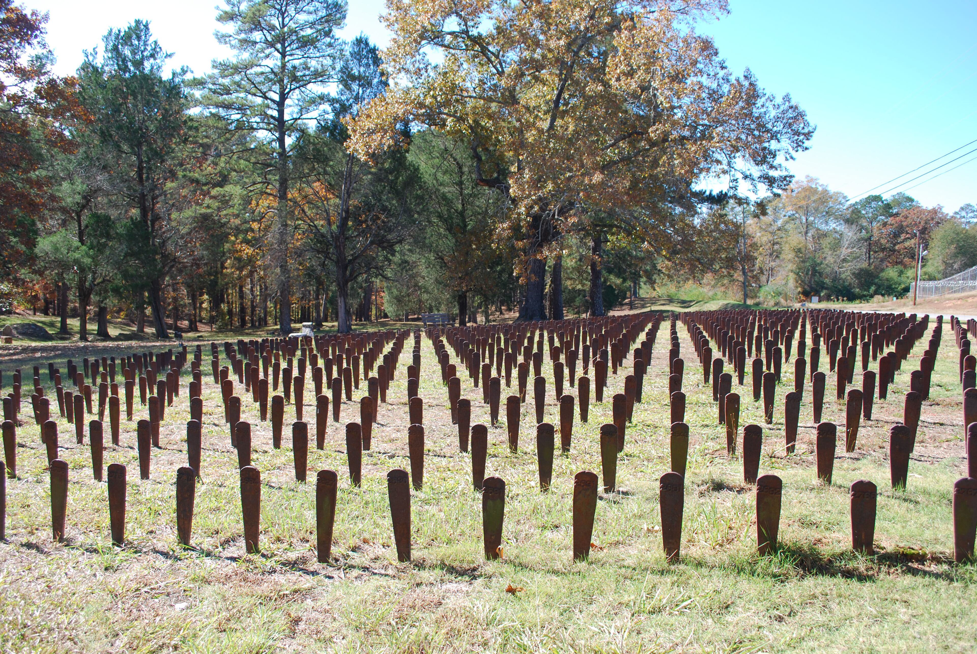 For decades, patients at the state psychiatric hospital in Milledgeville were buried on the facility's grounds, their graves marked only by a small metal stake. Groundskeepers tossed as many as 10,000 stakes into the woods in the 1960s, leaving the graves forever unmarked. In recent years, patient advocates have placed several hundred recovered markers in a memorial at the hospital's Cedar Lane Cemetery.