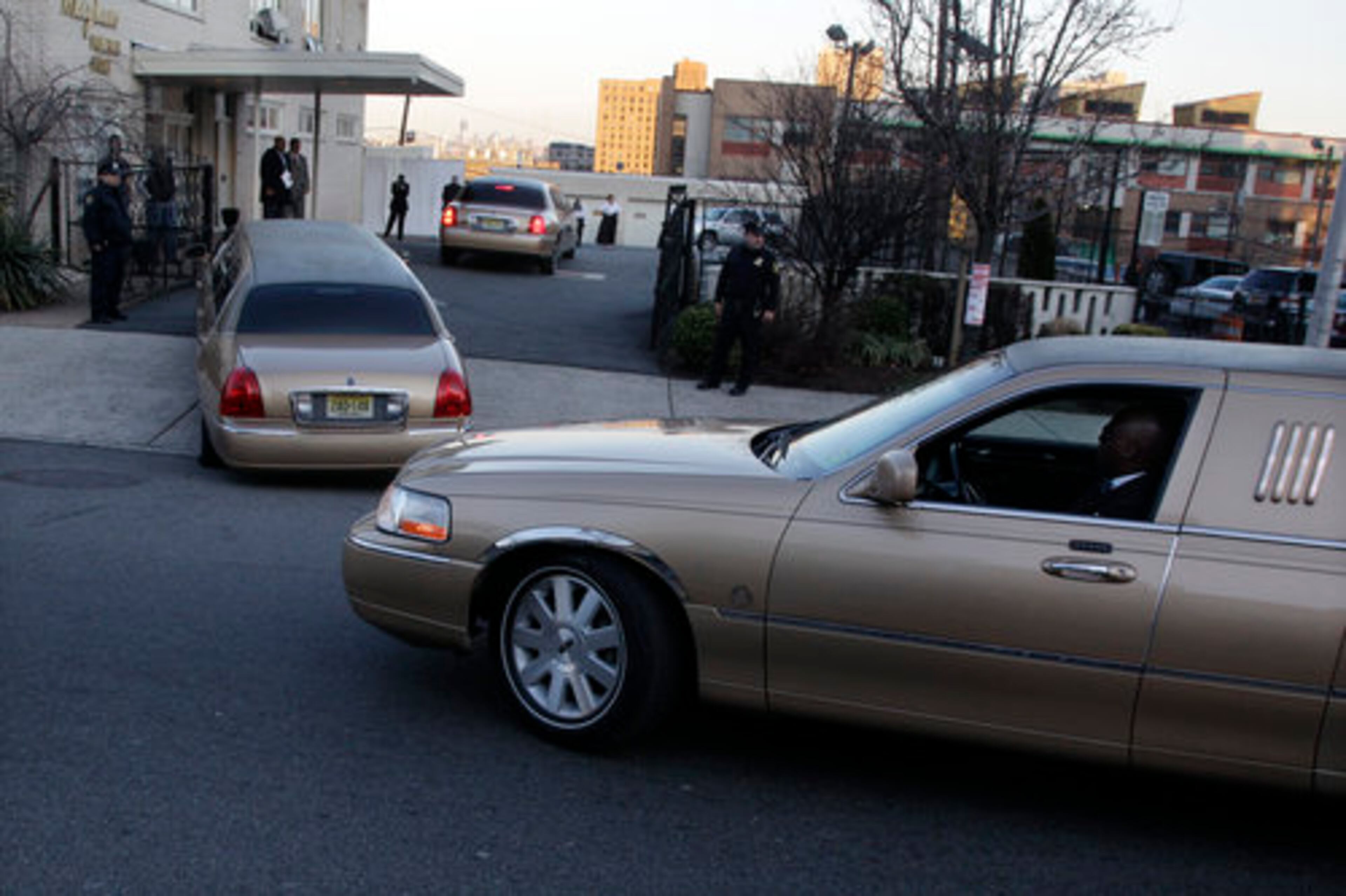 Three gold-colored limousines arrive with family members at Whigham Funeral Home in Newark, N.J., Friday, Feb. 17, 2012, for a viewing service for Whitney Houston.