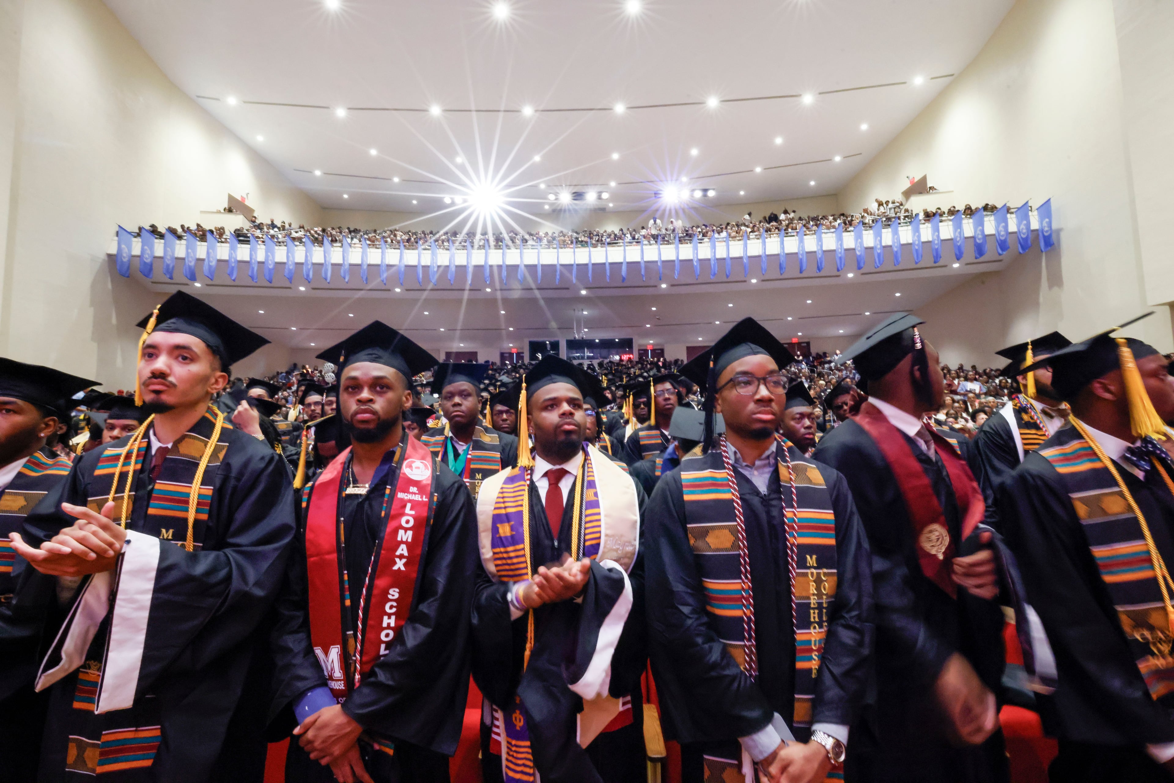 Graduates stand up as they prepare to receive their diplomas during the 141st Commencement Ceremony of Morehouse College on Sunday, May 18, 2025.(Miguel Martinez/ AJC)