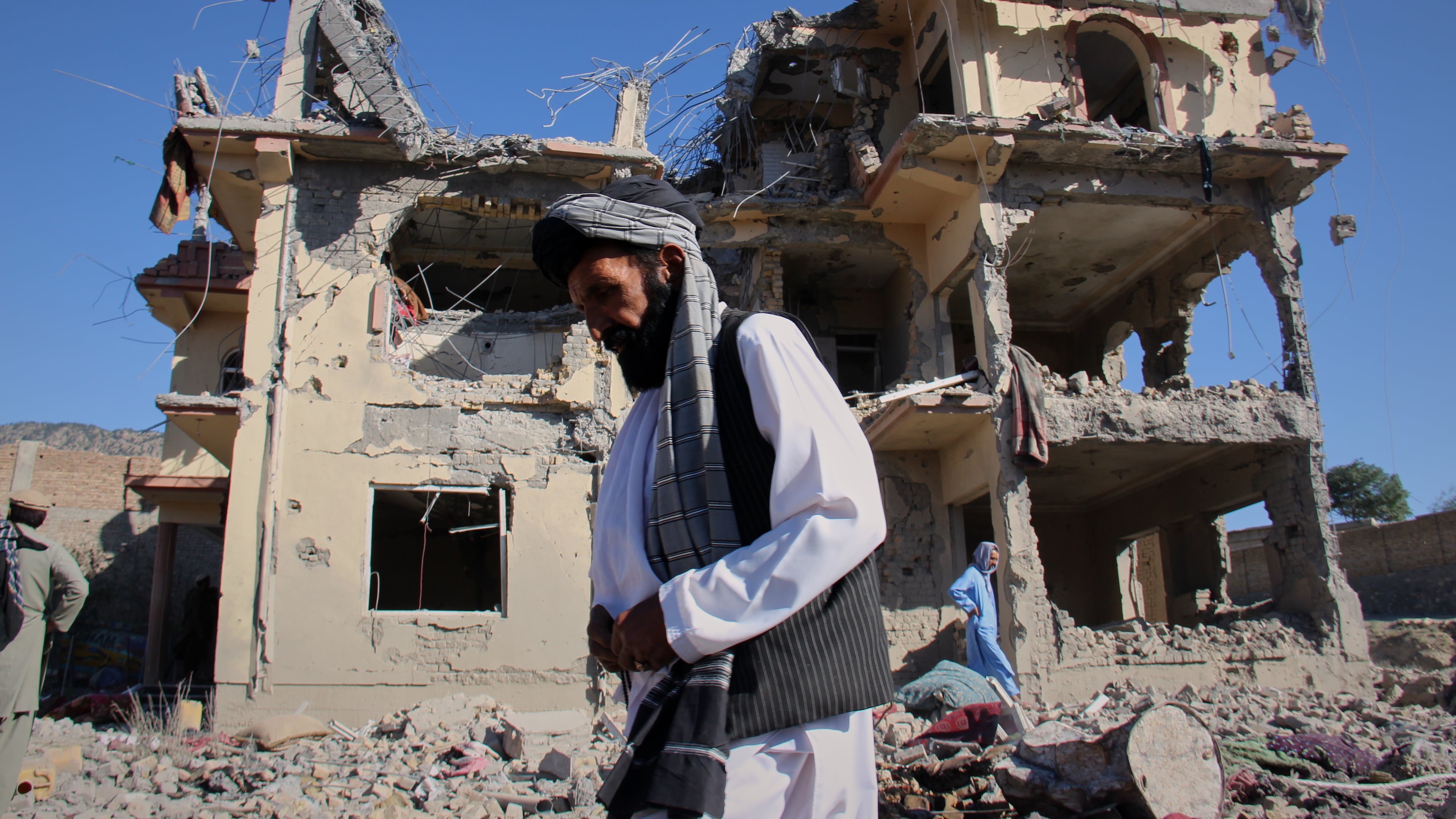 Residents walk through the rubble after what Taliban officials said were Pakistani airstrikes a day earlier that killed civilians, including children, in the village of Mandokhail, Chamkani district, Paktia province, Afghanistan, Monday, June 29, 2026. (AP Photo/Saifullah Zahir)