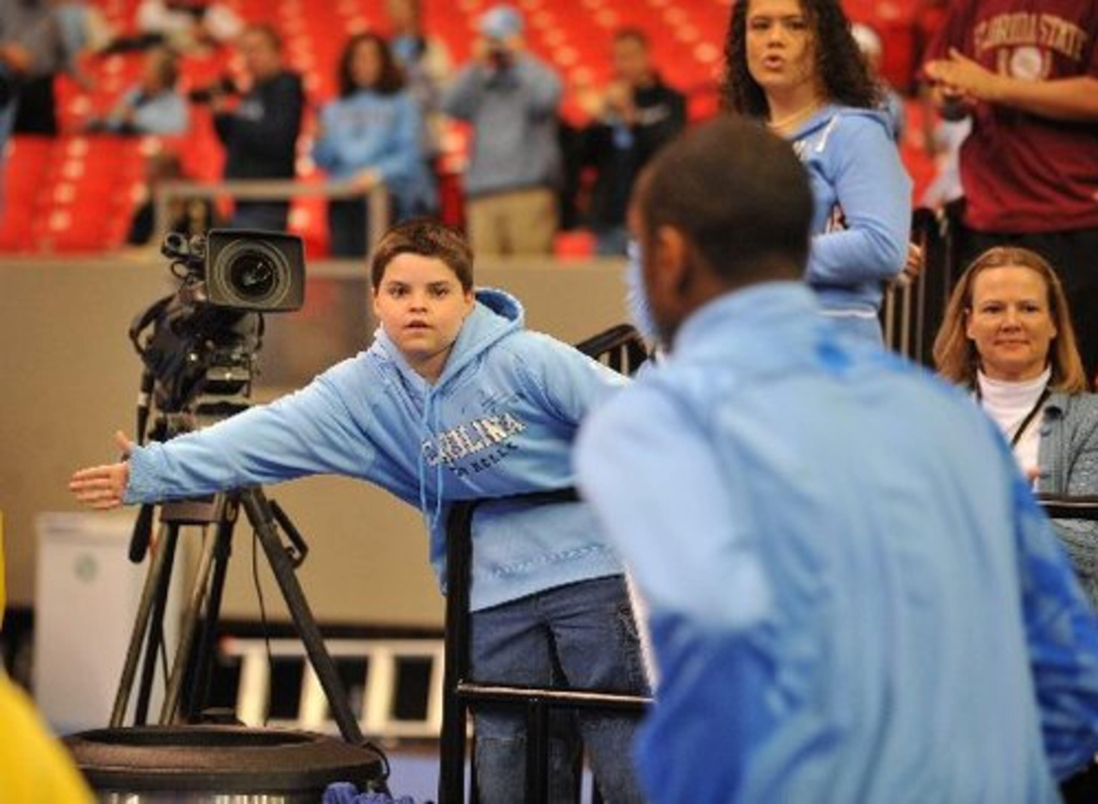 Robinson Price of Kannapolis, N.C., wants a hand-slap from the Heels as they exit the court after warming up.
