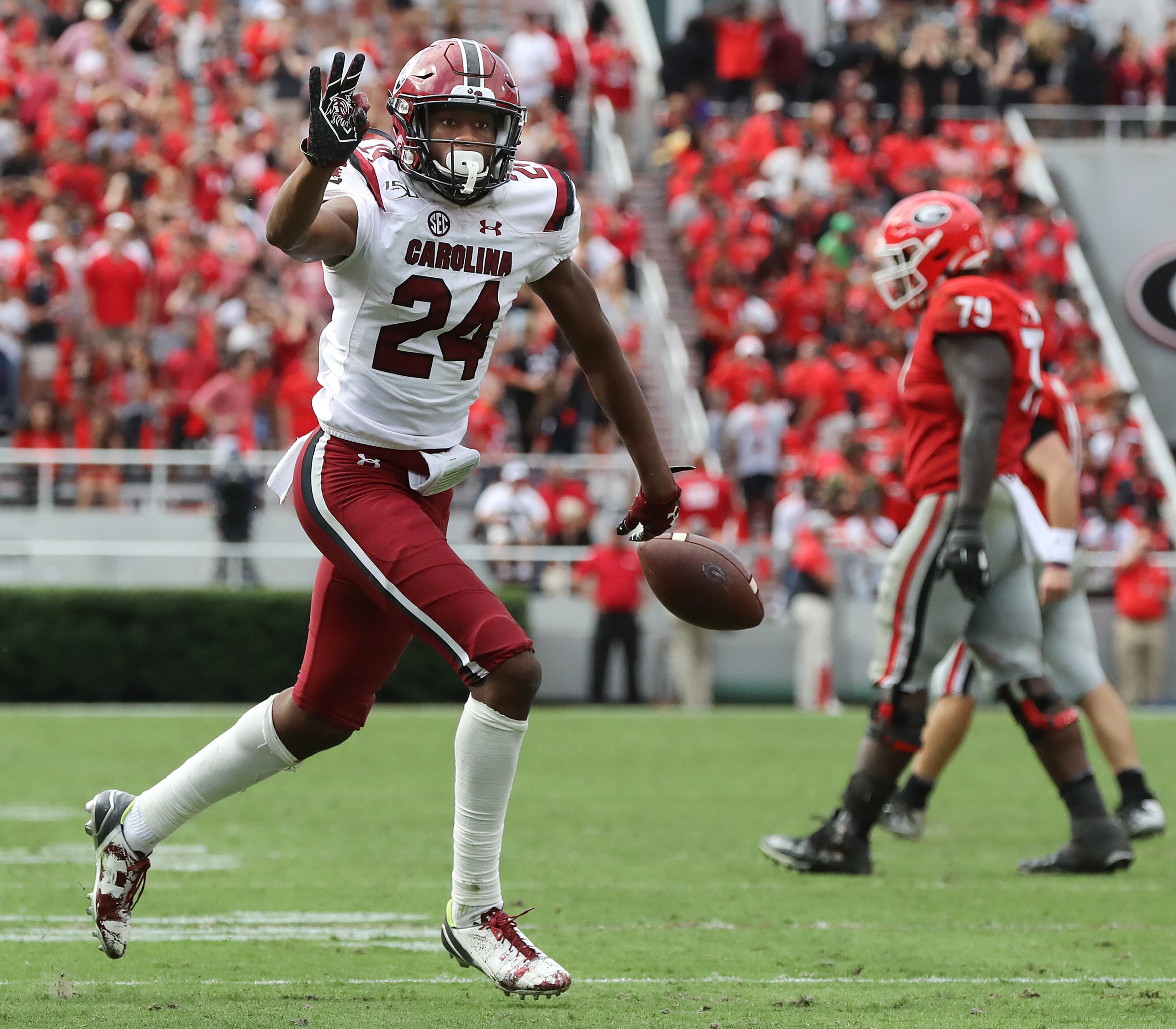 South Carolina defensive back Israel Mukuamu holds up three fingers reacts to intercepting Georgia quarterback Jake Fromm yet again during the first overtime period. Curtis Compton/ccompton@ajc.com