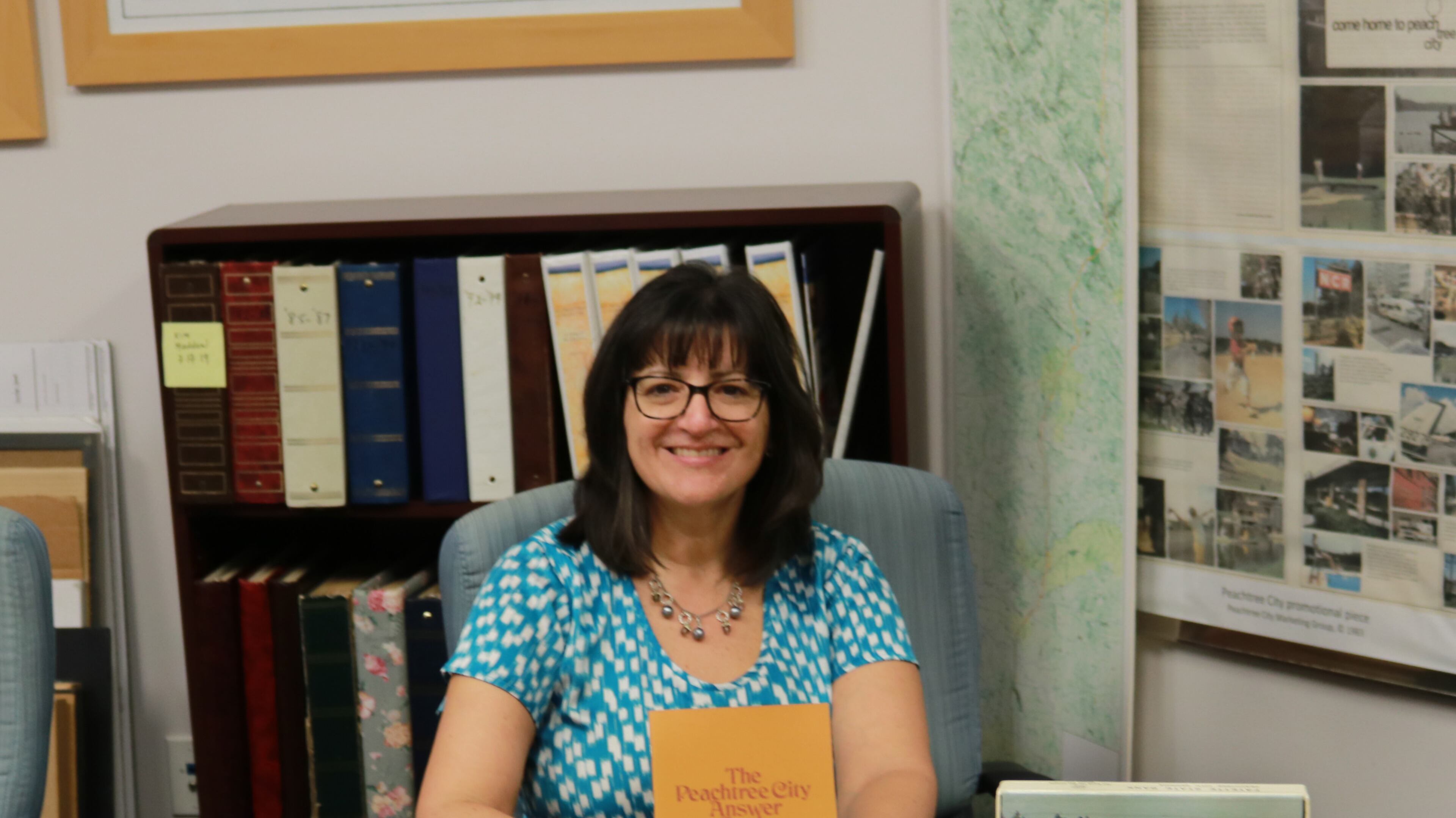 Peachtree City library administrator Jill Prouty shows off some of the historical artifacts already donated to its collection. Courtesy Peachtree City