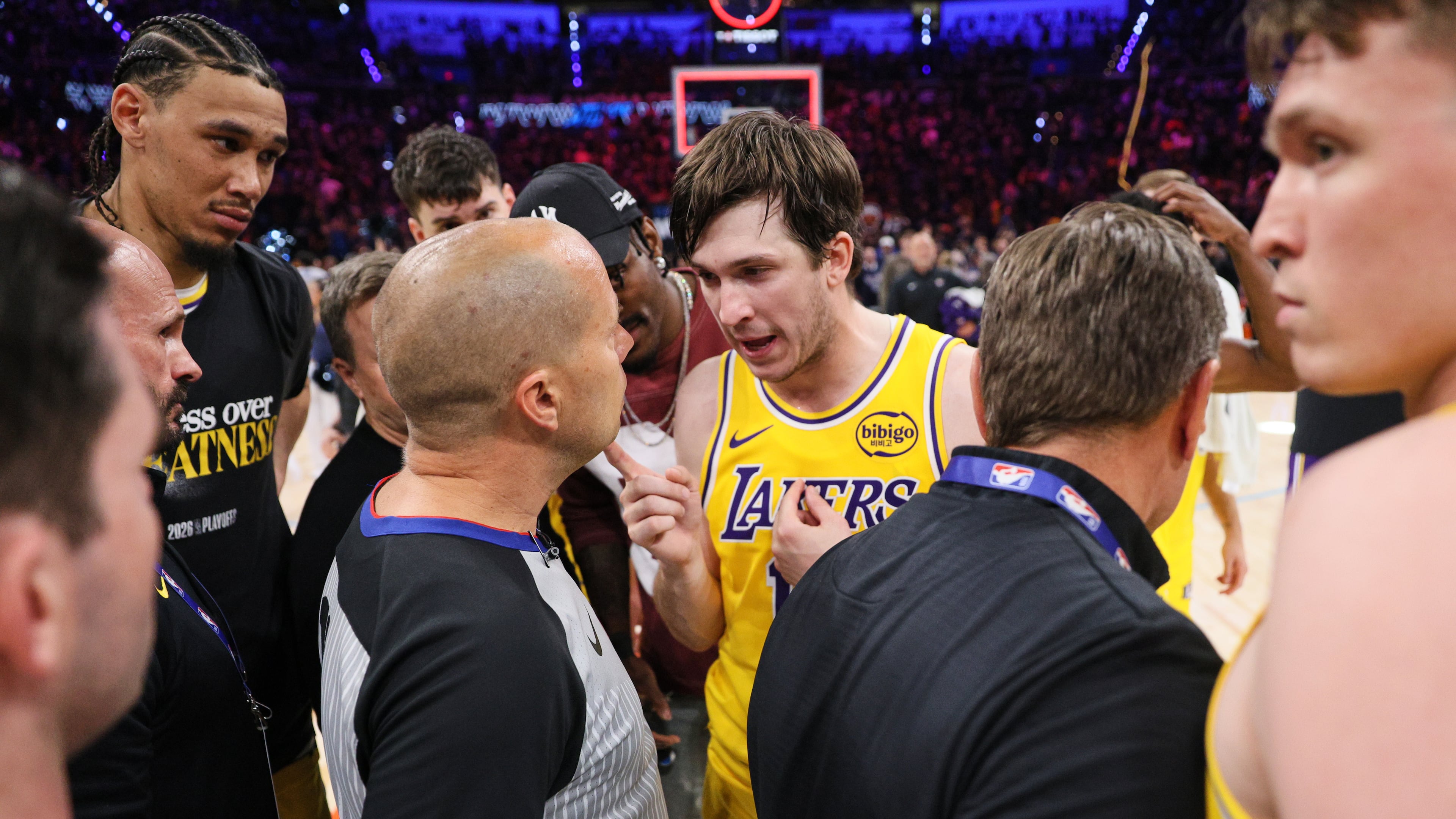 Los Angeles Lakers' Austin Reaves, center right, talks with referee John Goble, center, left, after the team's loss in Game 2 in a second-round NBA basketball playoffs series against the Oklahoma City Thunder Thursday, May 7, 2026, in Oklahoma City. (AP Photo/Nate Billings)