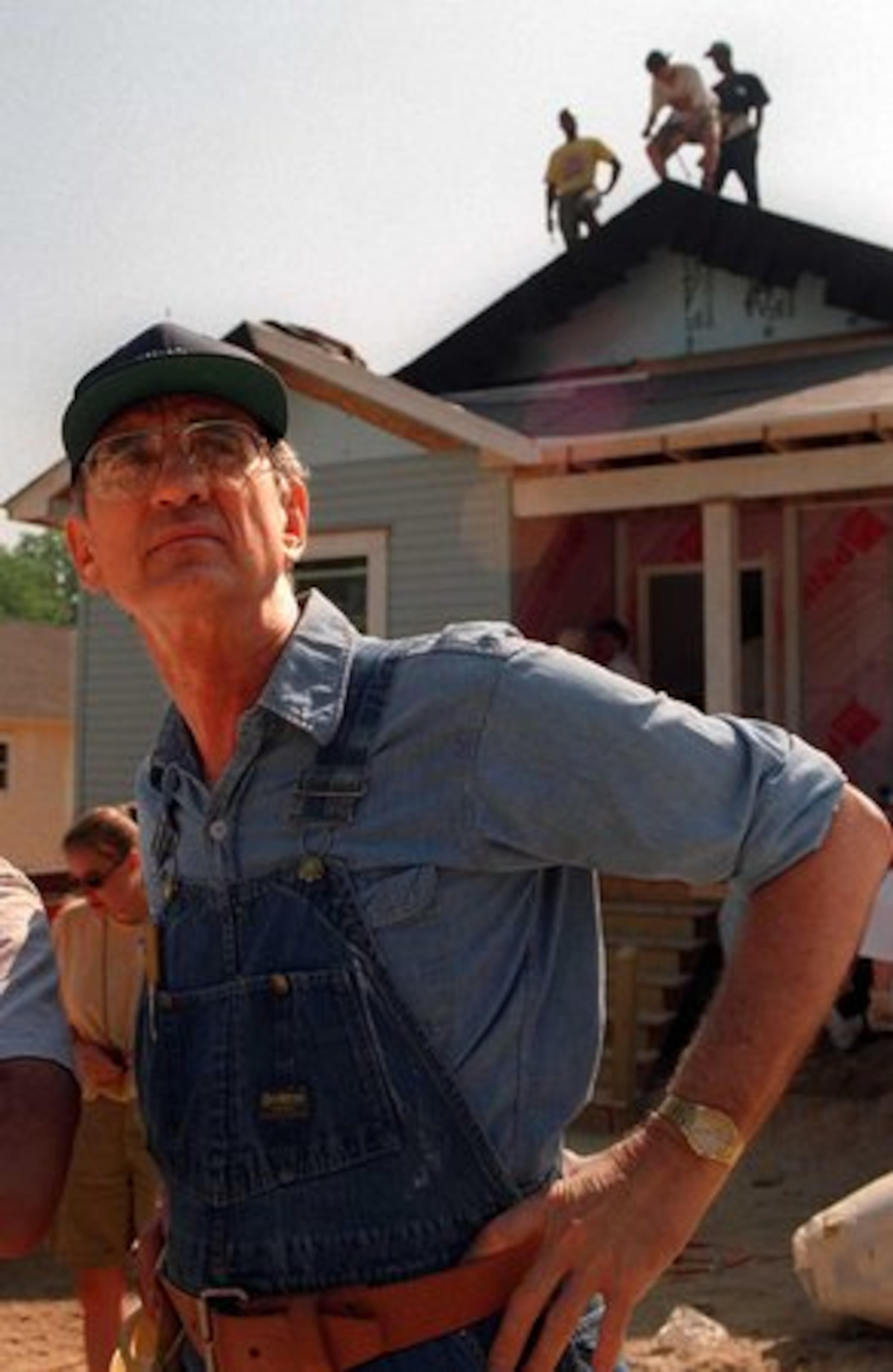 Millard Fuller surveys the work site of a 20-home building blitz in Peoplestown near Turner Field in Atlanta in 2005. Fuller took his family to live in Zaire (now the Democratic Republic of the Congo) as missionaries in 1973. Upon returning to the United States, the Fullers began building simple, decent houses for low-income families.