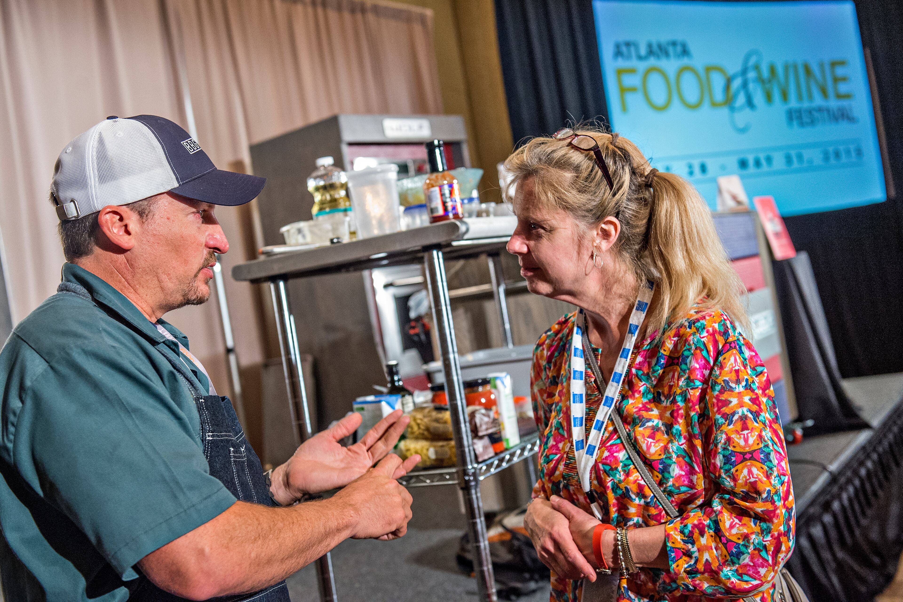 May 30, 2015 Atlanta - Chef Chris Lilly (left) speaks with Mary Lehner after finishing his demonstration during the Atlanta Food & Wine Festival at Loews Atlanta Hotel in Midtown on Saturday, May 30, 2015. Thousands of people tasted food and beverages prepared by chefs, brewers, distillers, wine makers and cocktail connoisseurs from all over the country. JONATHAN PHILLIPS / SPECIAL