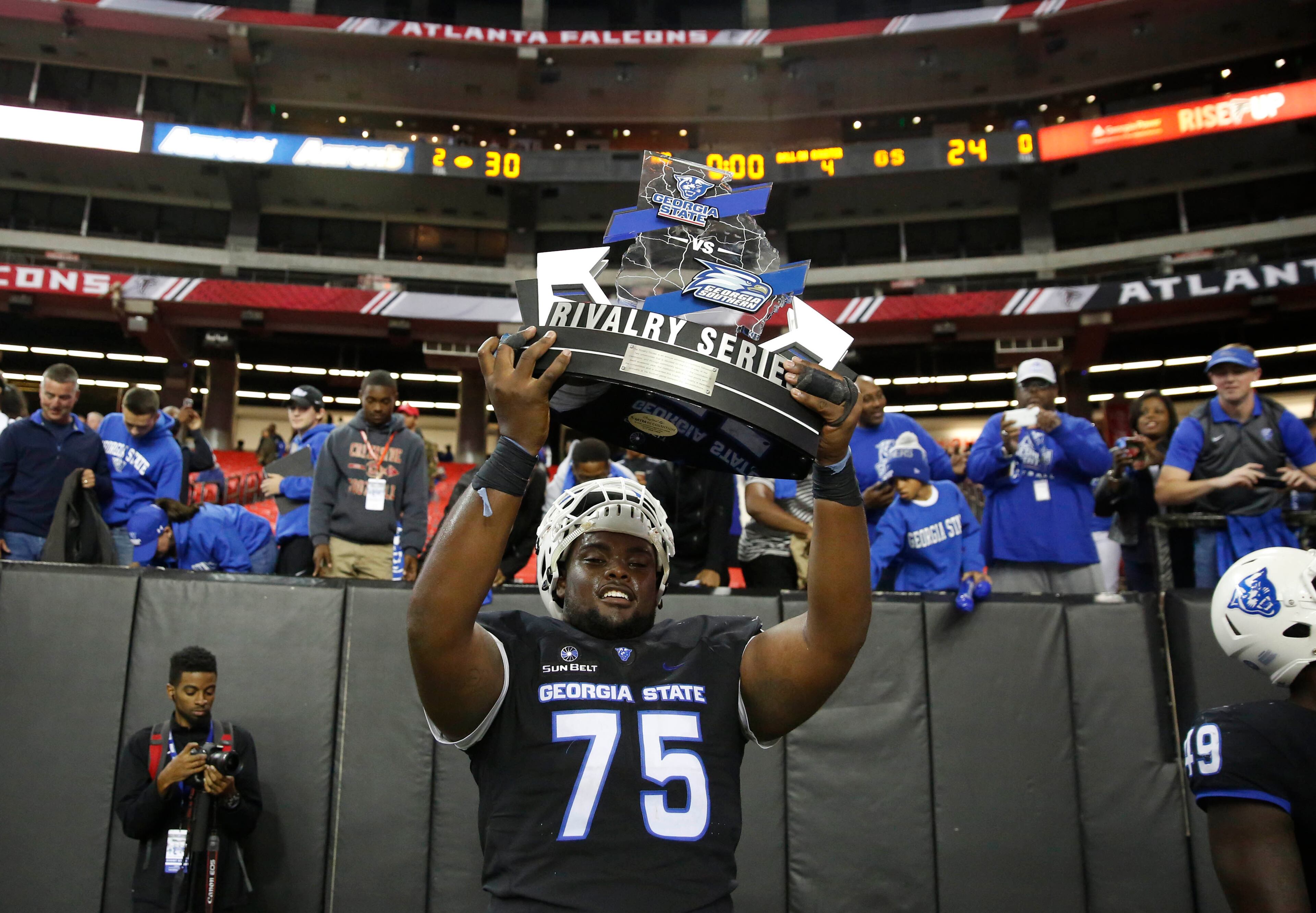 November 19, 2016 - Atlanta, Ga: Georgia State Panthers offensive tackle Michael Ivory (75) celebrate with the Rivalry Series trophy after their win against the Georgia Southern Eagles at the Georgia Dome Saturday November 19, 2016, in Atlanta, Ga. Georgia State won 30-24. PHOTO / JASON GETZ