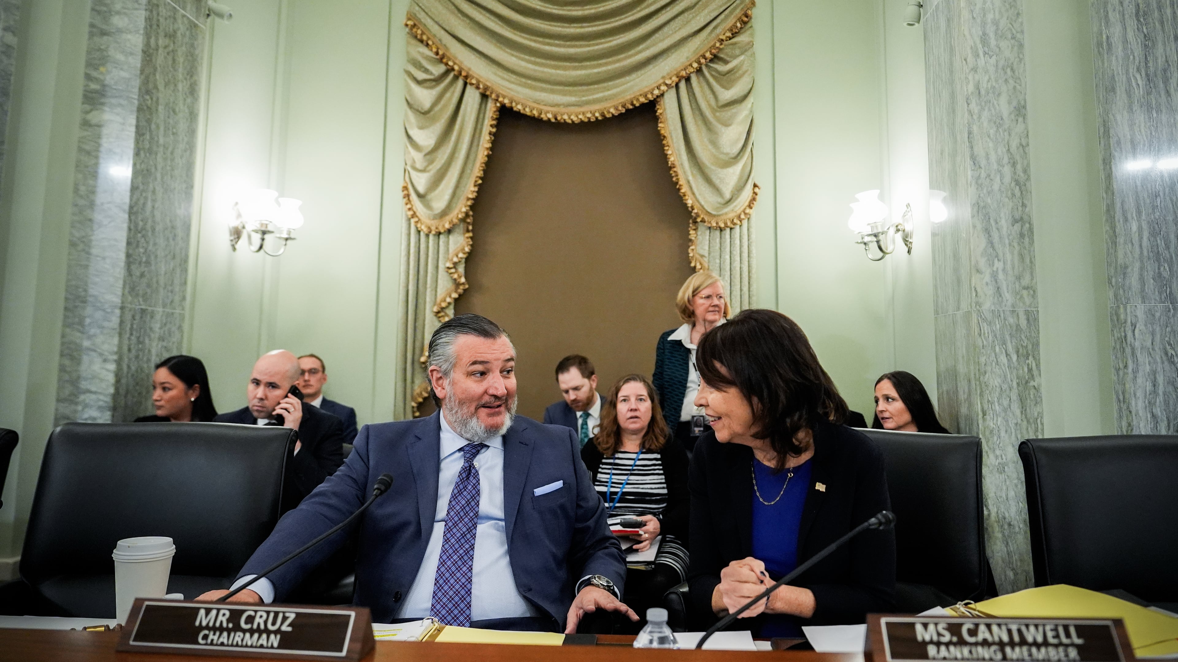 FILE - Sen. Ted Cruz, R-Texas, left, chairman of the Senate Commerce, Science and Transportation Committee, speaks with Sen. Maria Cantwell, D-Wash., right, before a hearing Wednesday, Nov. 19, 2025, on Capitol Hill in Washington. (AP Photo/Julia Demaree Nikhinson,File)