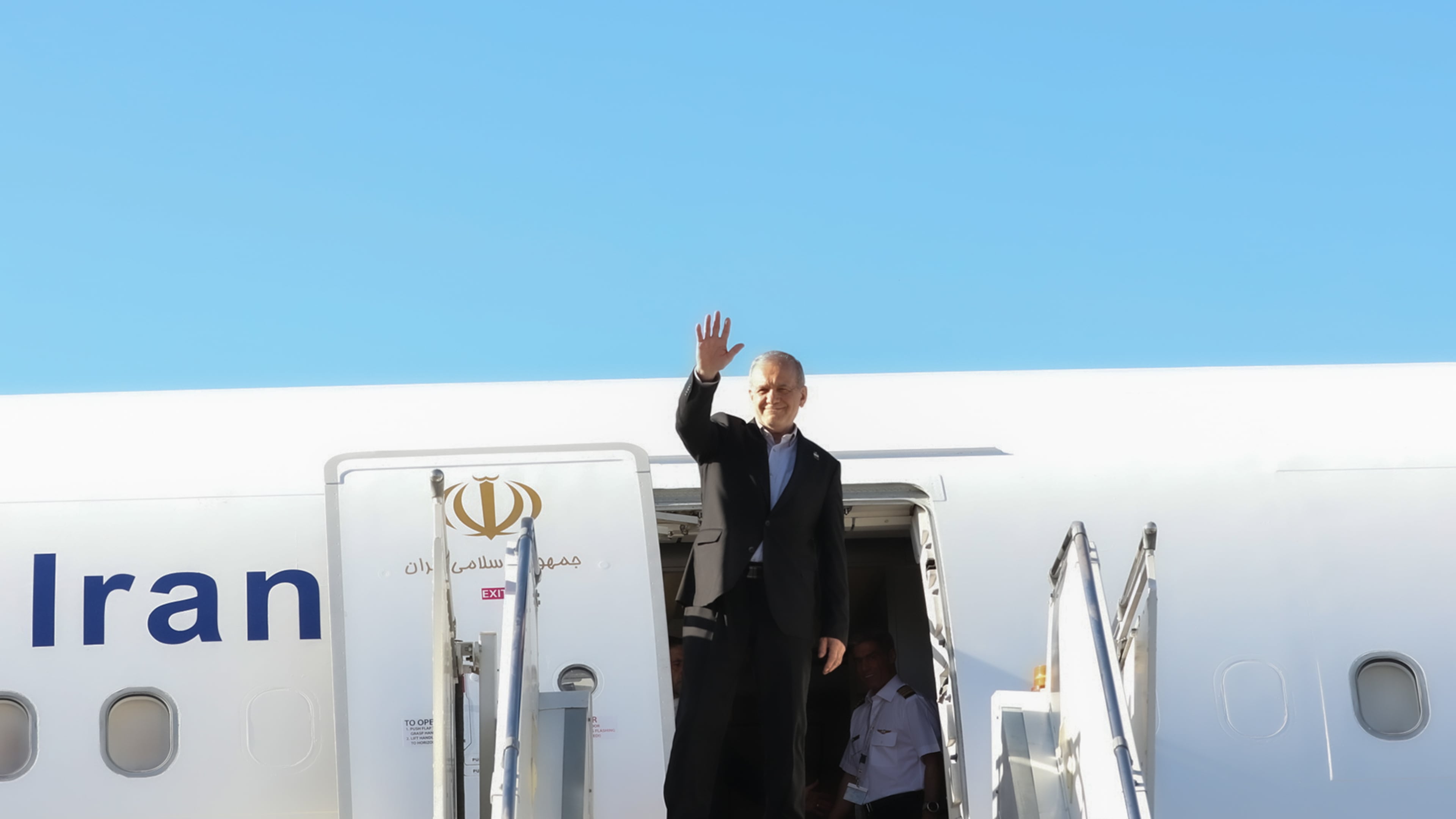In this photo released by the Iranian Presidency Office, President Masoud Pezeshkian waves to media and officials as he boards his plane while leaving Mehrabad airport for New York to attend the UN General Assembly, in Tehran, Iran, Tuesday, Sept. 22, 2026. (Iranian Presidency Office via AP)