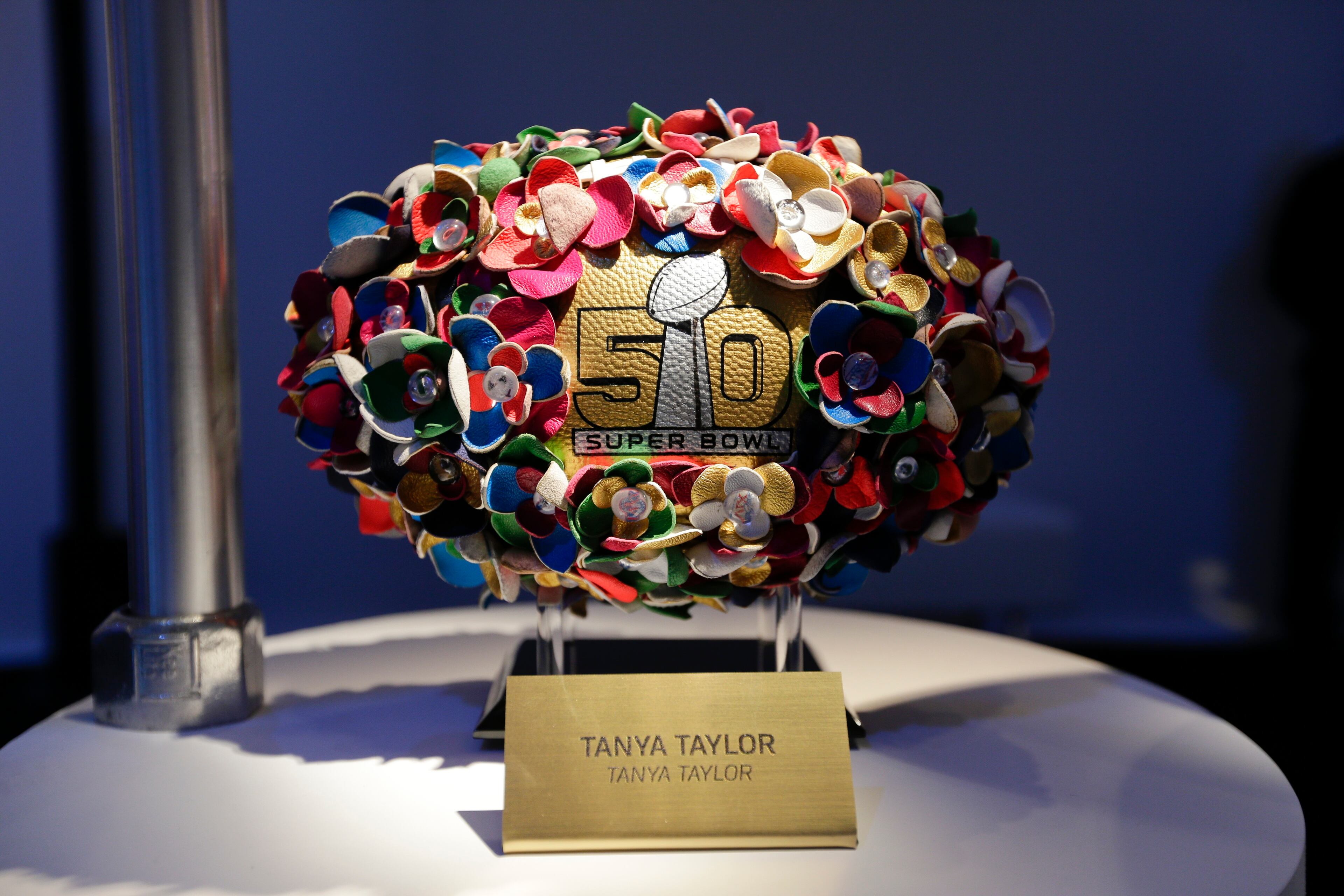 A Tanya Taylor designed football is displayed at the unveiling of the CFDA Footballs Wednesday, Jan. 20, 2016, at the NFL headquarters in New York. In celebration of Super Bowl 50 and in support of the NFL Foundation, the NFL and the Council of Fashion Designers of America have collaborated on 50 Bespoke Designer Footballs created by CFDA Members. (AP Photo/Frank Franklin II)
