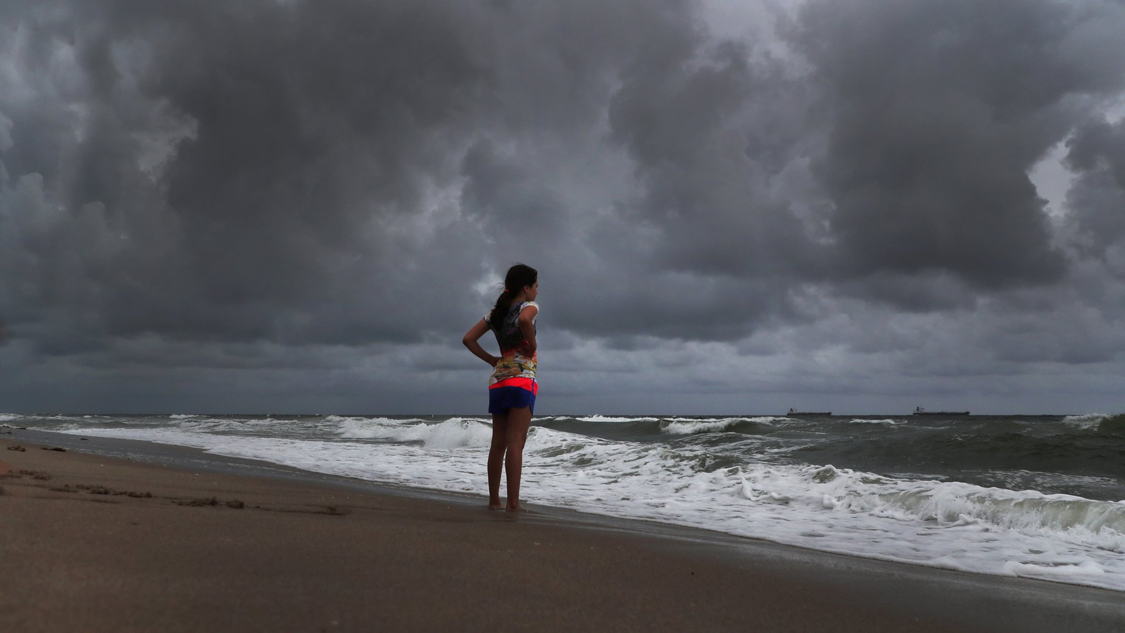 Alicia Herrera, 10, visiting from Germany doesn’t let dark clouds ruin her day at beach Friday, May 25, 2018 in Fort Lauderdale, Fla. A flood watch is expected for South Florida on Saturday morning as a result of Subtropical Storm Alberto. (Carline Jean/Sun Sentinel/TNS)