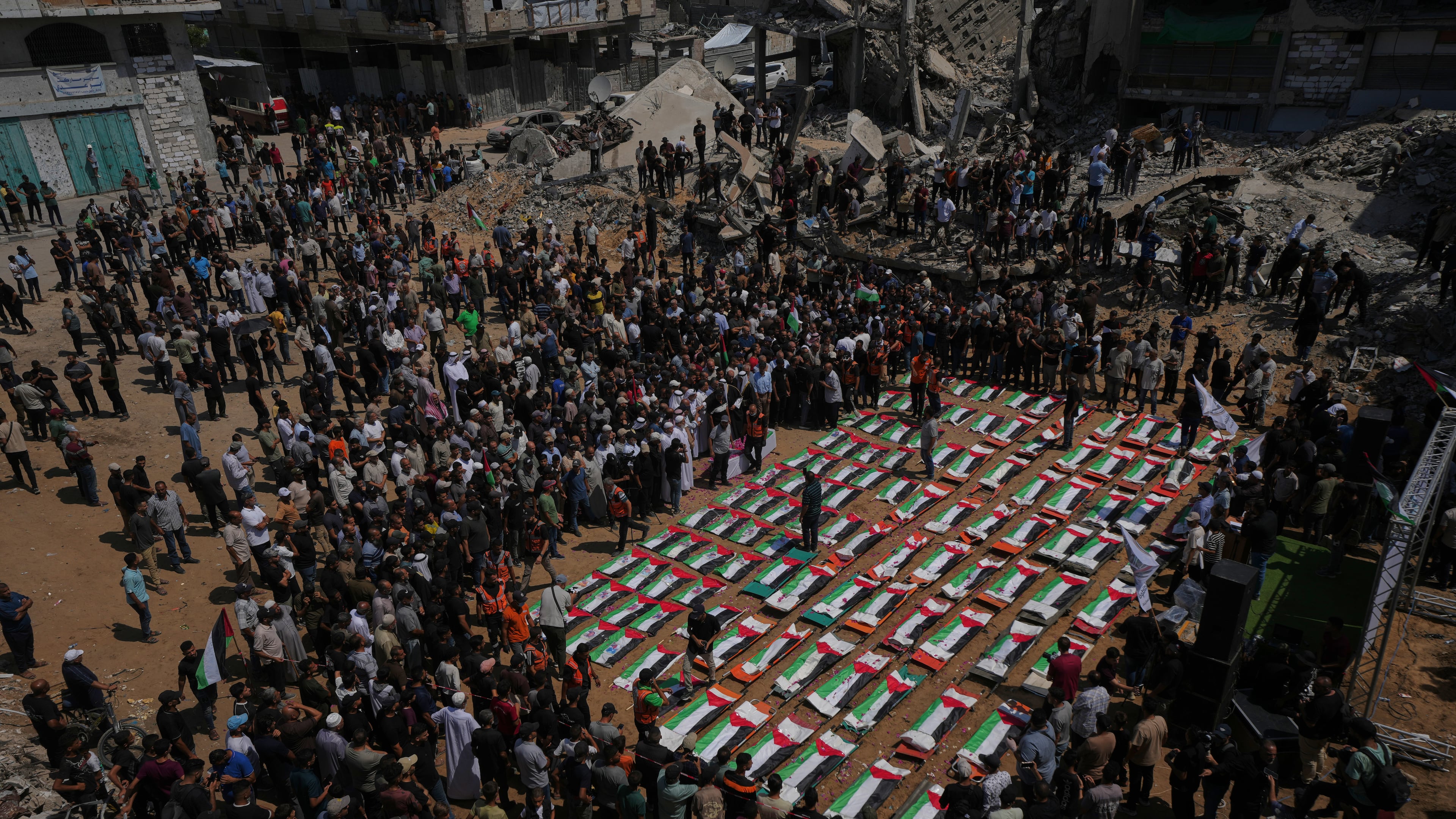 Bodies of members of the Hassayna and Abu Sharia families, killed in an Israeli strike in 2023 and recently recovered from the rubble, are draped in Palestinian flags during their funeral in Gaza City, Tuesday, Aug. 4, 2026. (AP Photo/Jehad Alshrafi)