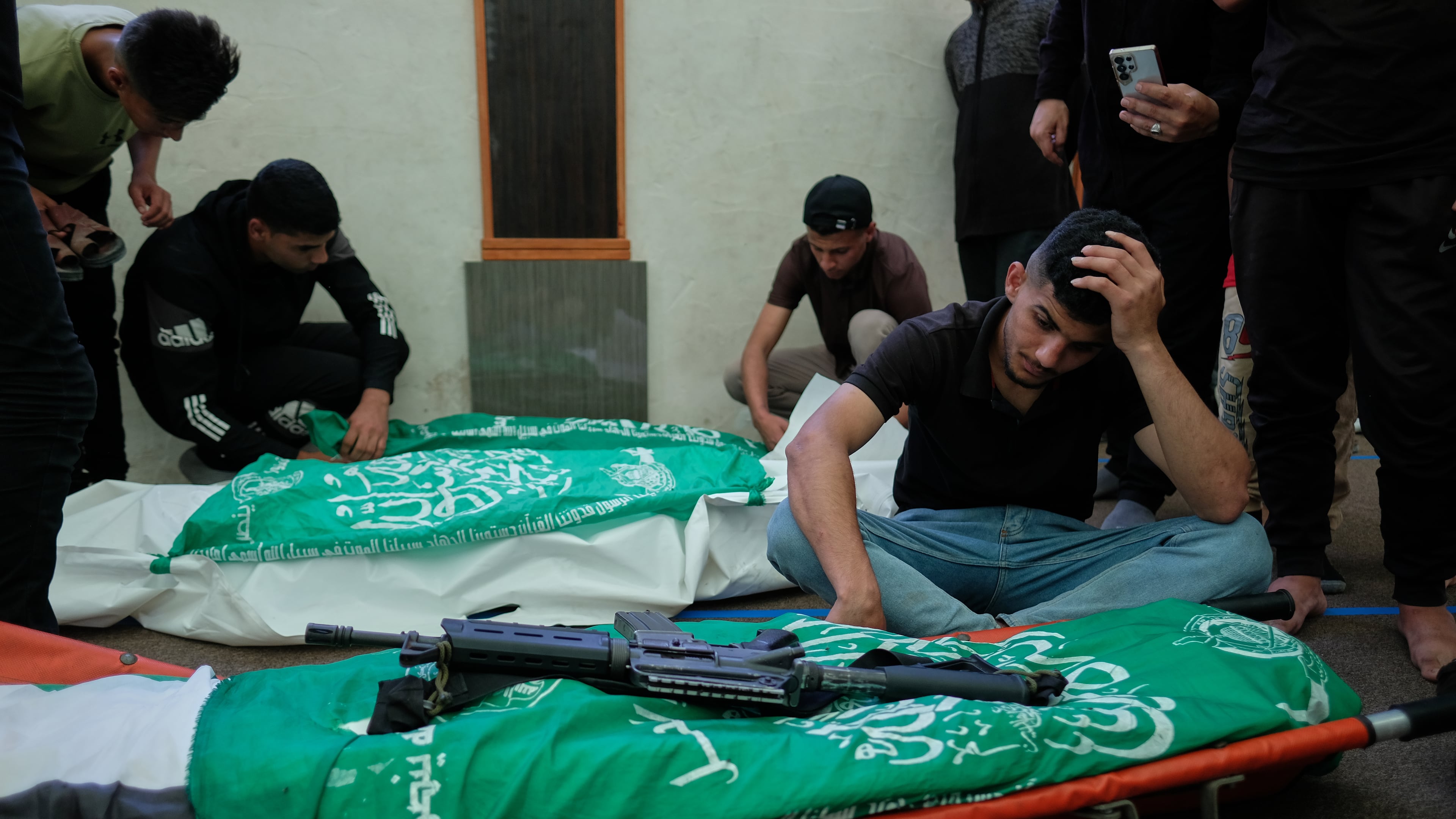 Palestinians mourn over the bodies of Hamas militant Imad Isleim, foreground, his wife and daughter, who were killed in an Israeli military strike, during their funeral at Al-Shafi'i Mosque in Gaza City, Thursday, May 28, 2026. (AP Photo/Jehad Alshrafi) CORRECTION: Corrects surname from al-Salem to Isleim