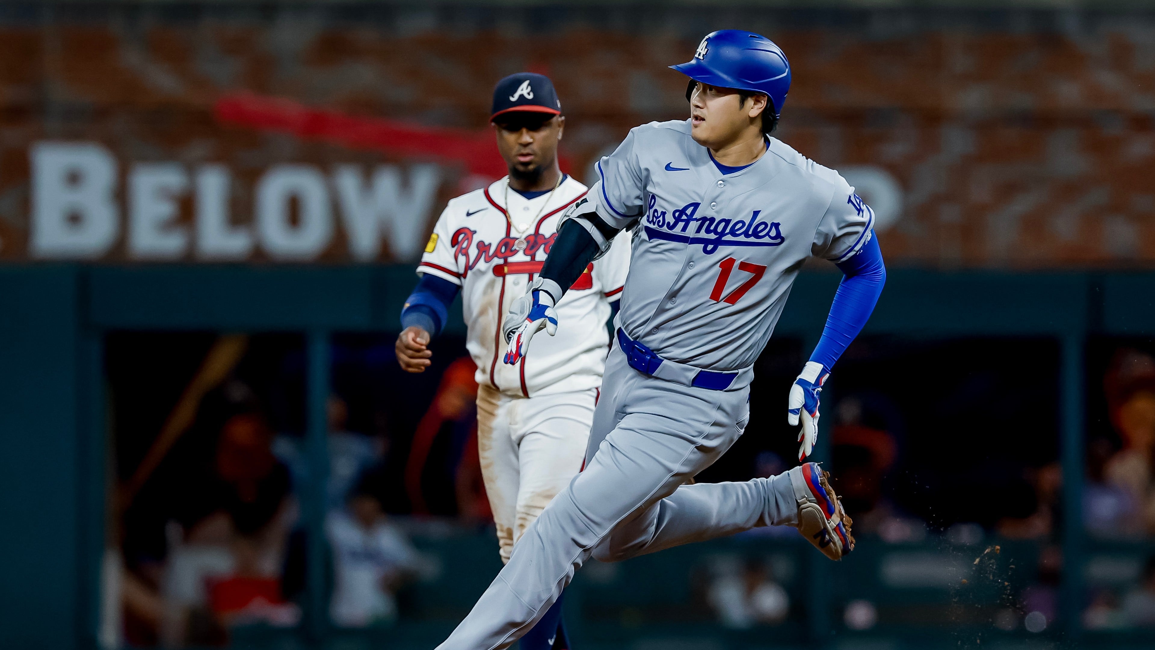 Los Angeles Dodgers designated hitter Shohei Ohtani (17) rounds second base after hitting a triple as Atlanta Braves second baseman Ozzie Albies (1) looks on during the ninth inning of a baseball game, Tuesday, Aug. 25, 2026, in Atlanta. (AP Photo/Erik S. Lesser)