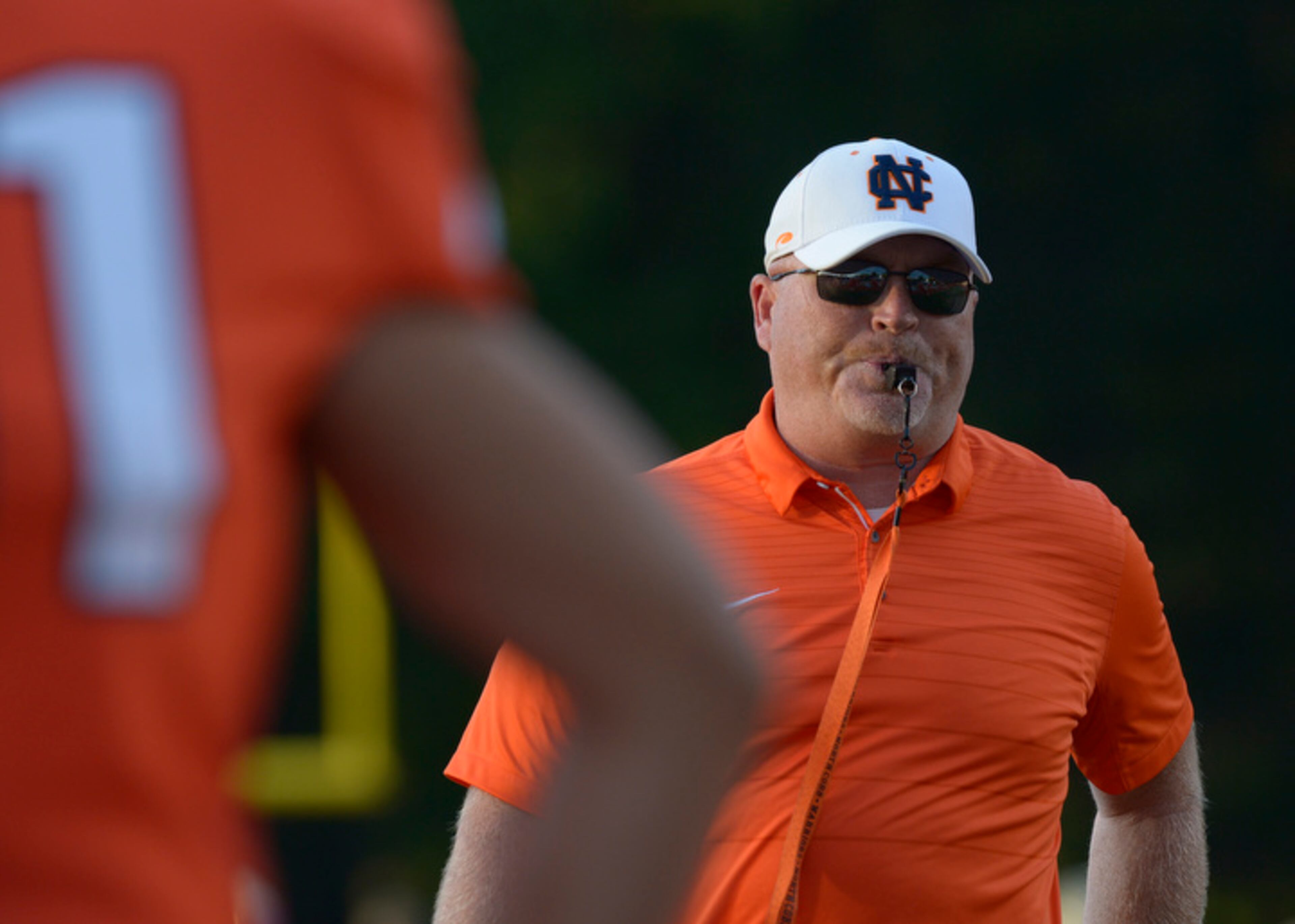 Kennesaw, Ga. -- North Cobb head coach Shane Queen runs the Warriors through their pre-game warm up before their game against McEachern at North Cobb Friday, October 6, 2017. Special/Daniel Varnado