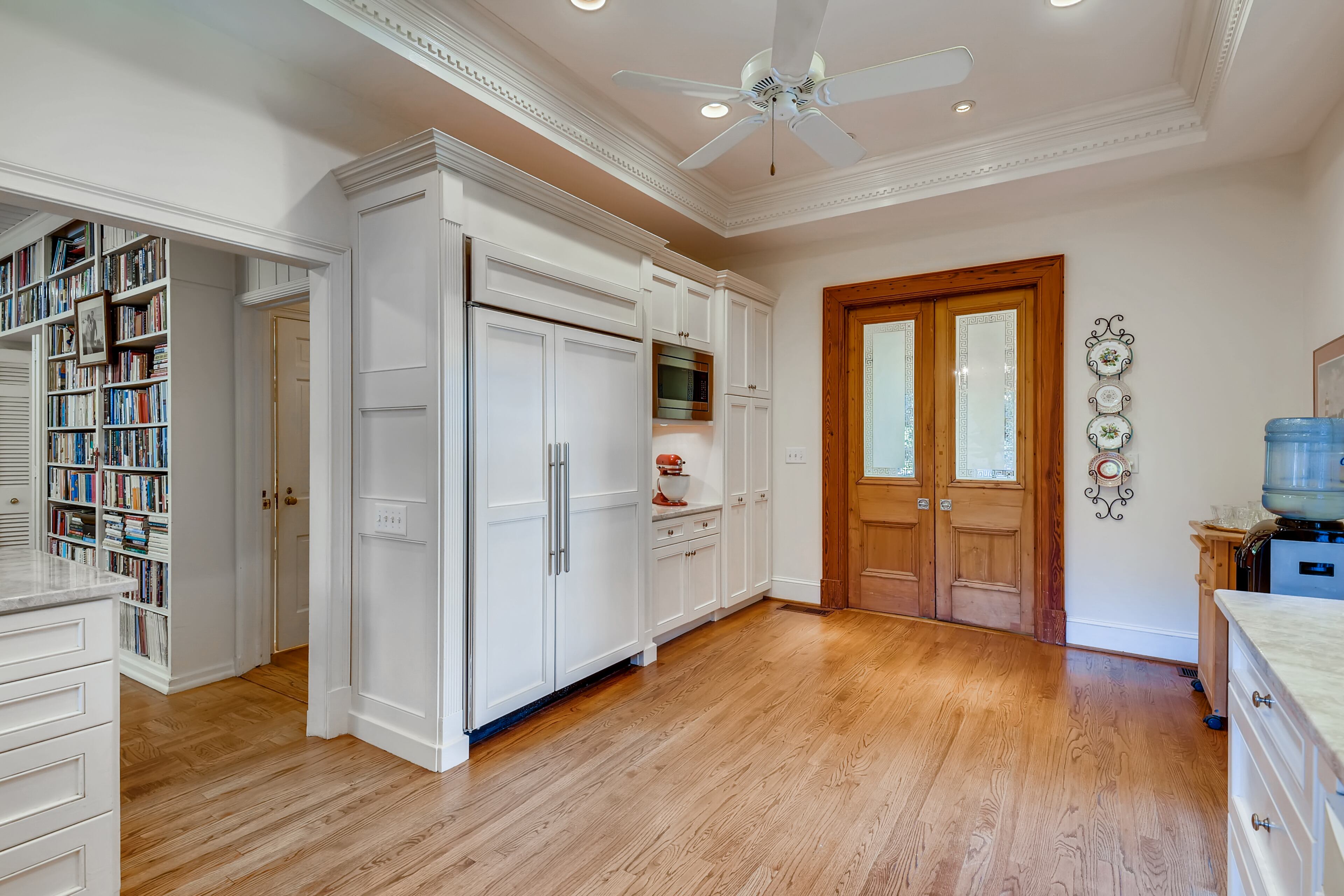 The kitchen boasts quartzite counters, high ceilings, casement windows and opens to the family room and terrace. Text by Jean Bird