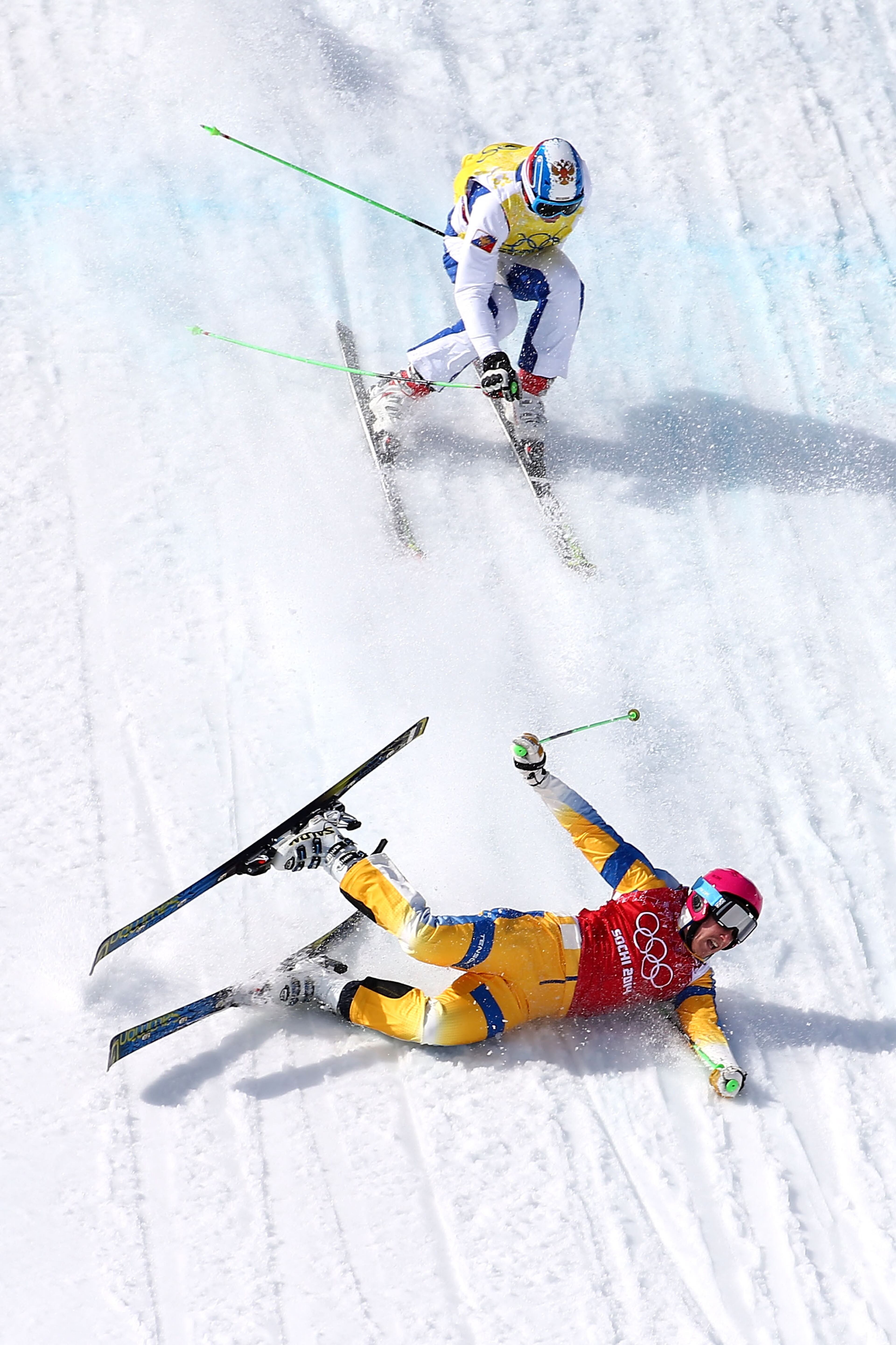 Victor Oehling Norberg of Sweden crashes to the snow followed by Egor Korotkov of Russia during the Freestyle Skiing Men's Ski Cross Quarter Finals on day 13 of the 2014 Sochi Winter Olympic at Rosa Khutor Extreme Park on February 20, 2014 in Sochi, Russia.