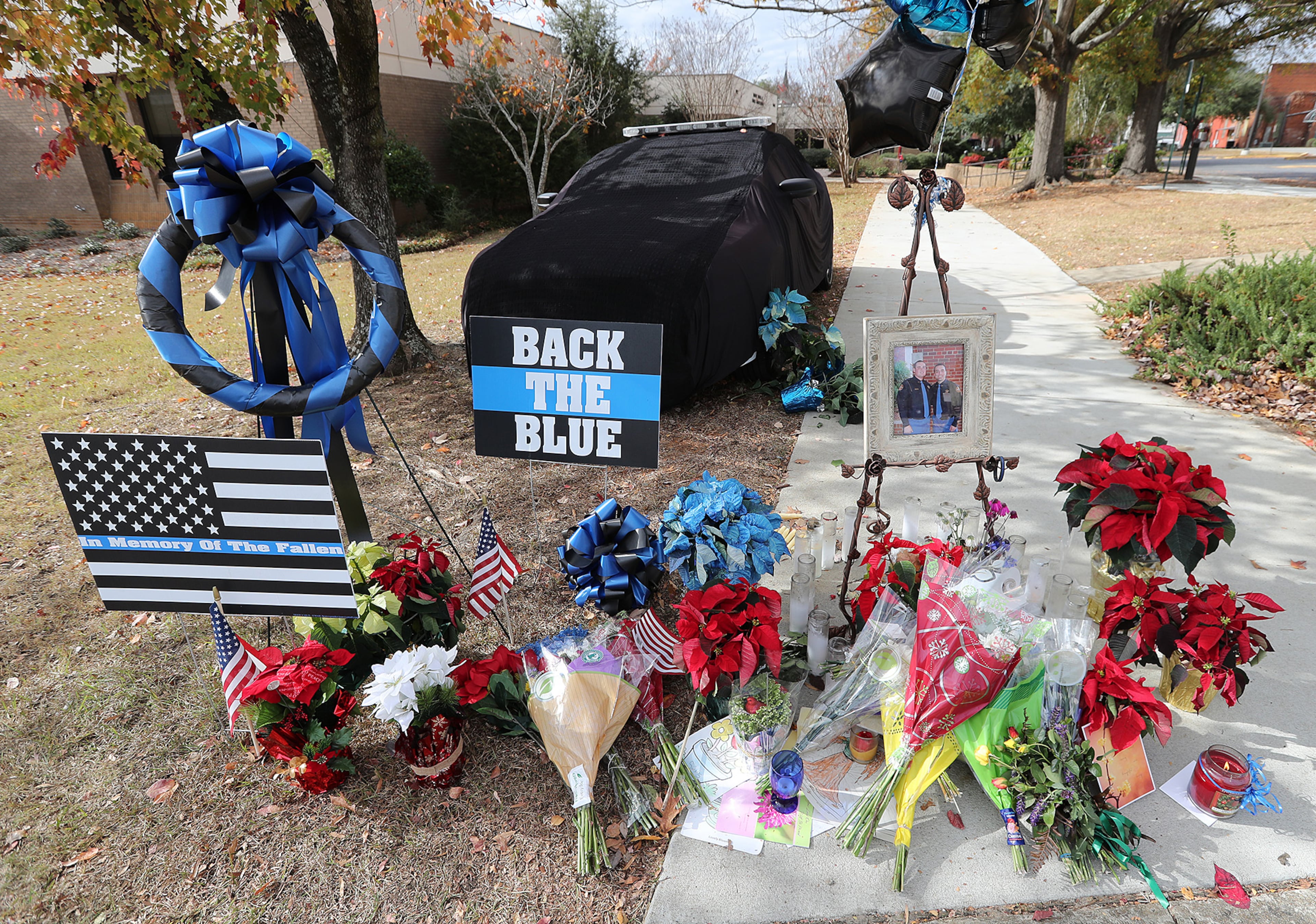 December 11, 2016, AMERICAS: A memorial for Americus police officer Nicholas Ryan Smarr, his patrol car covered in black, sits outside the Russell Thomas, Jr., Public Safety Building on Sunday, Dec. 11, 2016, in Americas. Officer Smarr and Georgia Southwestern State University campus police officer Jody Smith were killed responding to a domestic dispute. Curtis Compton/ccompton@ajc.com