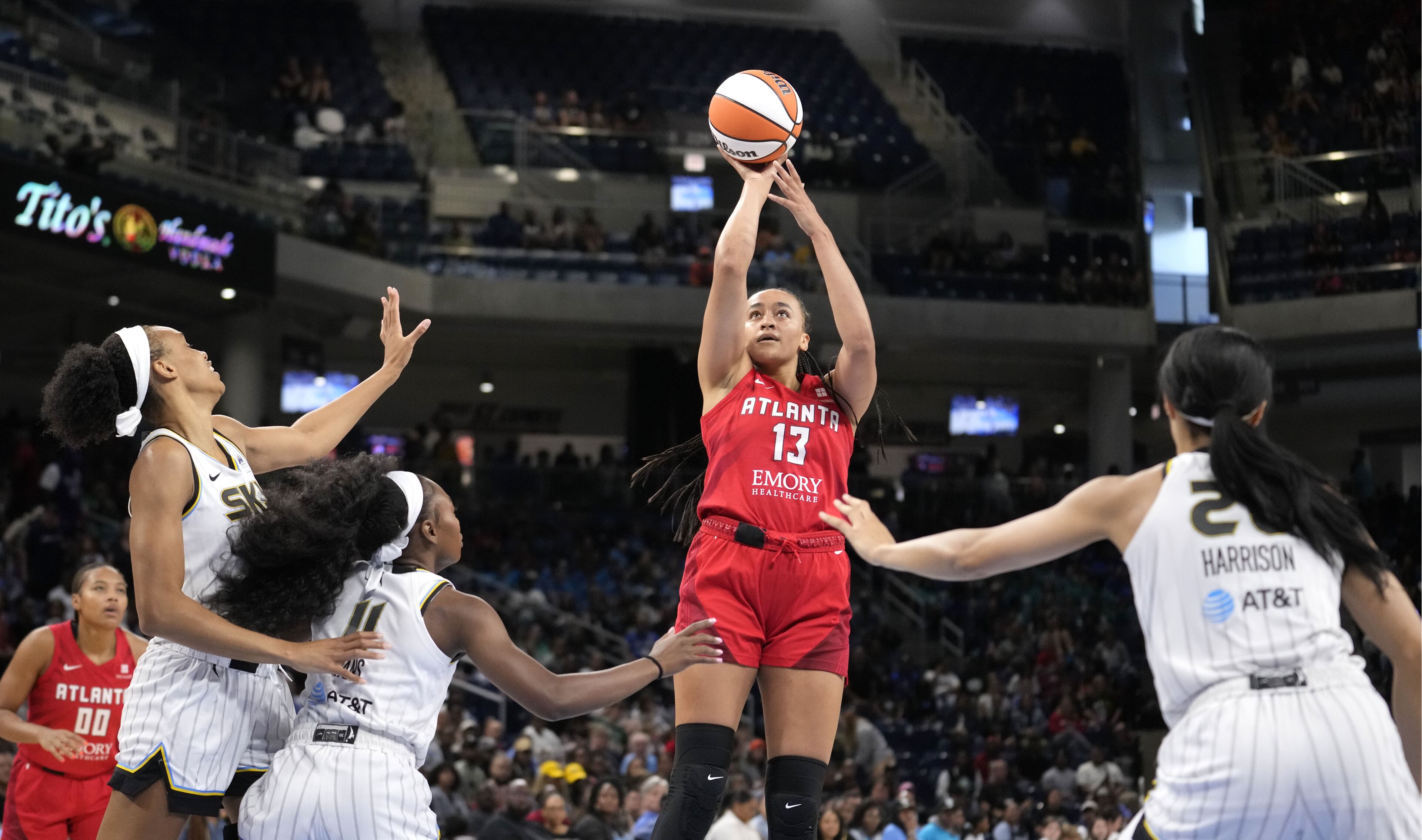 Atlanta Dream's Haley Jones (13) shoots as Chicago Sky defenders watch during the first half of a WNBA basketball game Wednesday, July 10, 2024, in Chicago. Chicago pulled away in the fourth quarter for the 78-69 victory. (AP