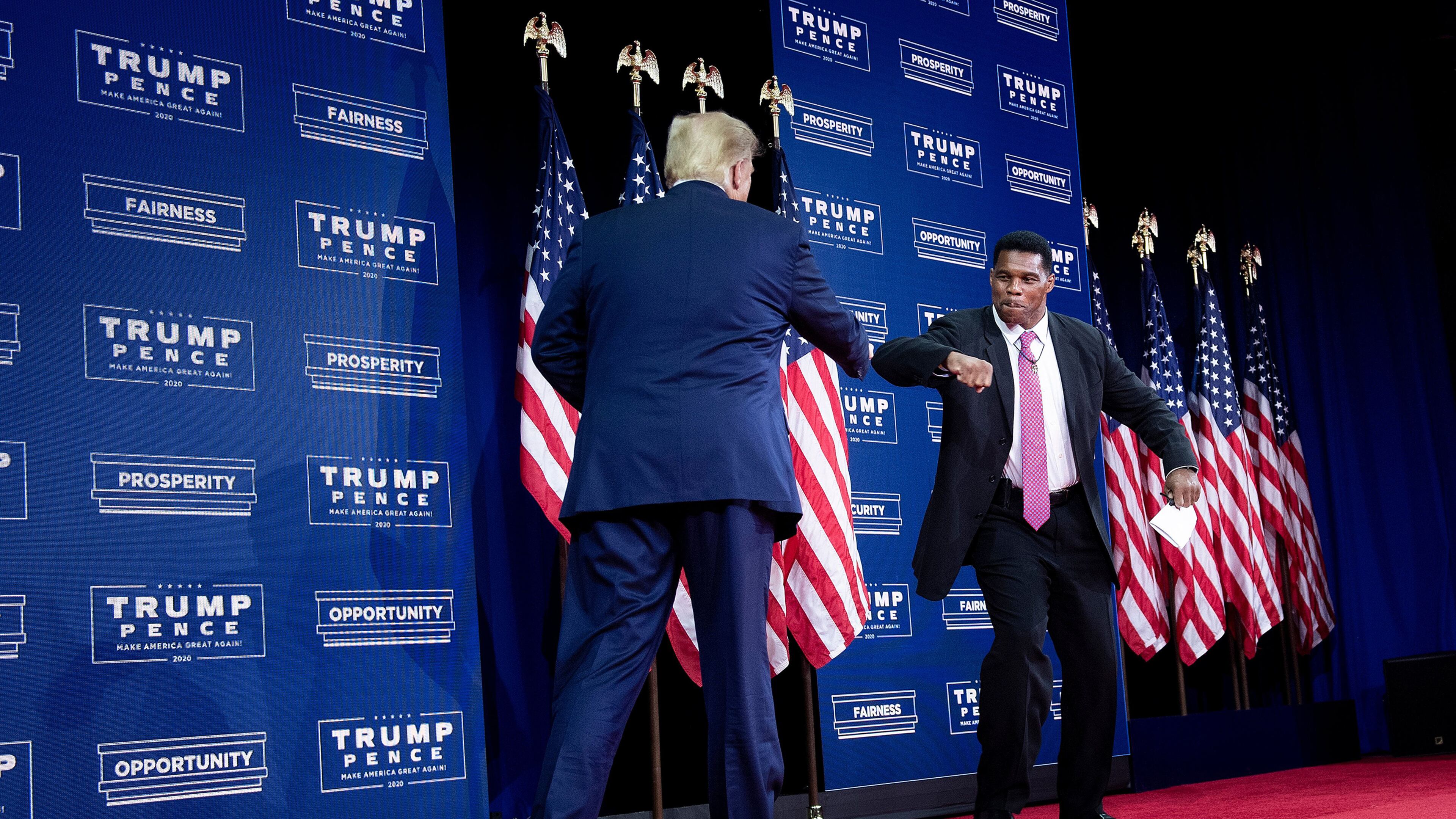 President Donald Trump is greeted by NFL Hall of Famer Herschel Walker during an event for black supporters at the Cobb Galleria Centre in Atlanta on September 25, 2020. (Brendan Smialowski/AFP via Getty Images/TNS)