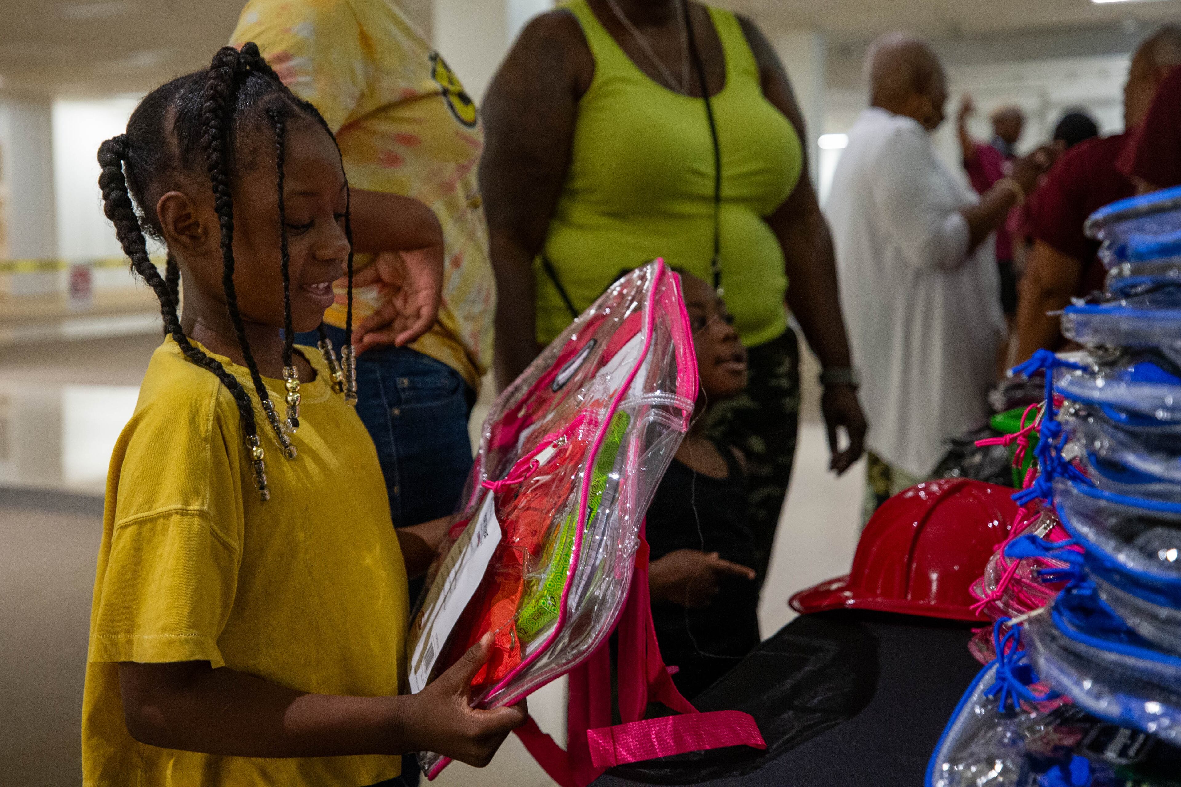 Kylenn Smith receives a free school supply kit and clear backpack at the 20th annual Back-to-School Bash at Greenbriar Mall in Atlanta on Saturday, July 22, 2023. (Katelyn Myrick/katelyn.myrick@ajc.com)