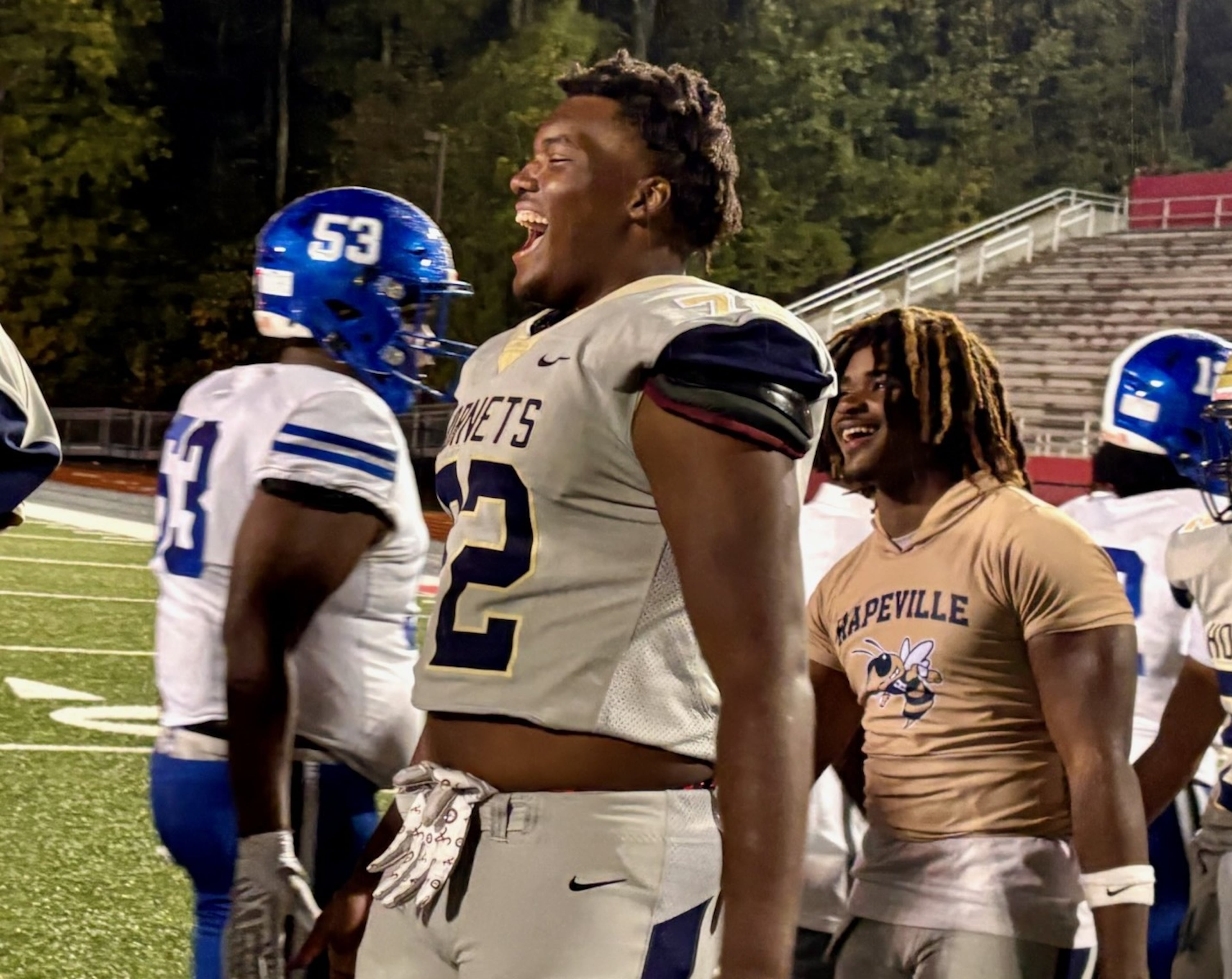 Hapeville Charter offensive lineman Chris Booker enjoys a laugh in the handshake line after the Hornets' 34-7 win over Washington High on Oct. 9, 2025 at Banneker High. (Ken Sugiura/AJC)