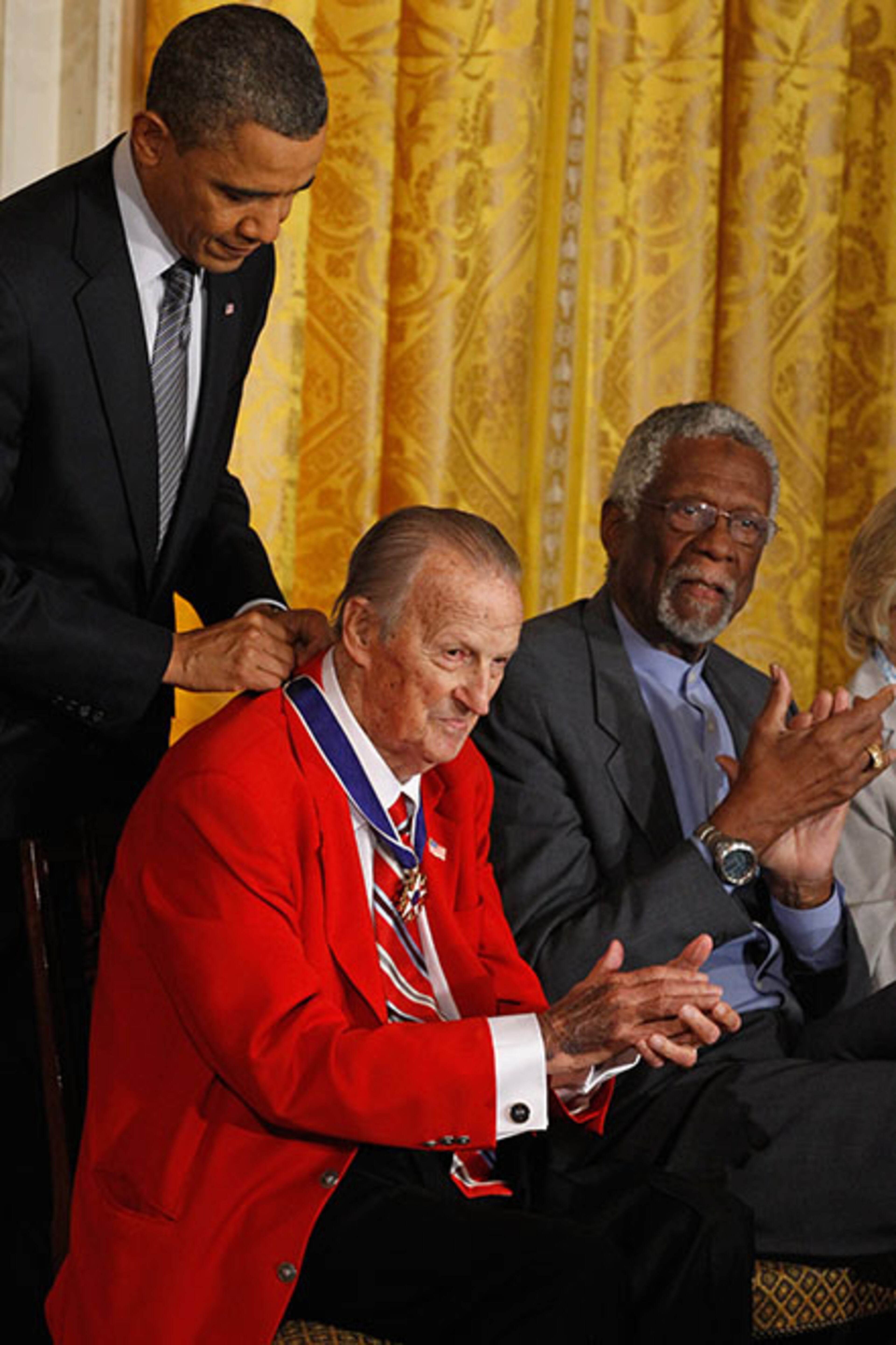 WASHINGTON, DC - FEBRUARY 15: U.S. President Barack Obama (L) presents Baseball Hall of Fame member Stan Musial the 2010 Medal of Freedom as Basketball Hall of Fame member and human rights activist Bill Russell (R) applauds in the East Room of the White House February 15, 2011 in Washington, DC. Obama presented the medal to twelve pioneers in sports, labor, politics and arts. (Photo by Chip Somodevilla/Getty Images)