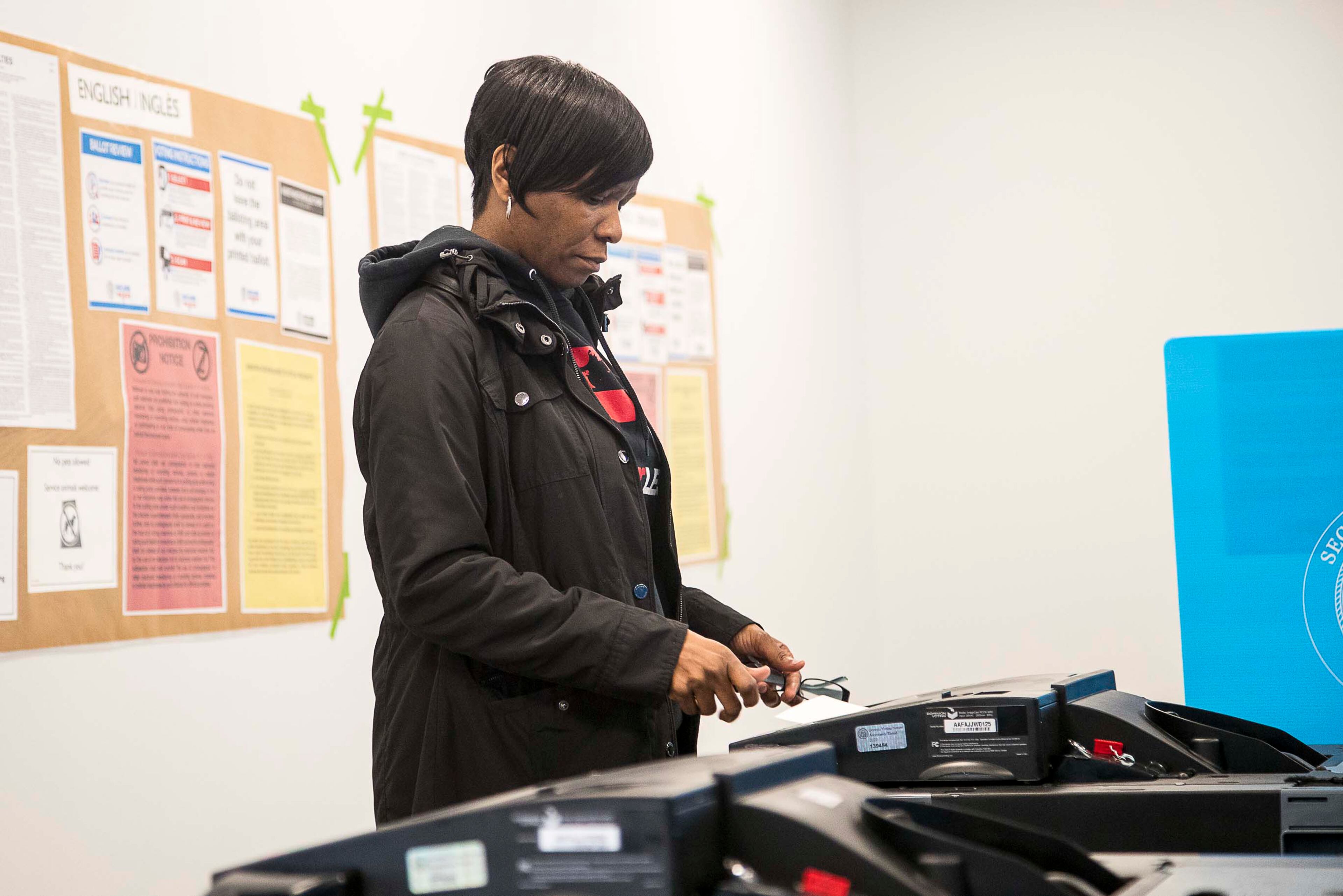 03/02/2020 -- Lawrenceville, Georgia -- Ronita Carr of Lawrenceville feeds her paper ballot into a machine during early voting for the presidential primary at the Gwinnett Voter Registrations and Elections office building in Lawrenceville, Monday, March 2, 2020. (ALYSSA POINTER/ALYSSA.POINTER@AJC.COM)