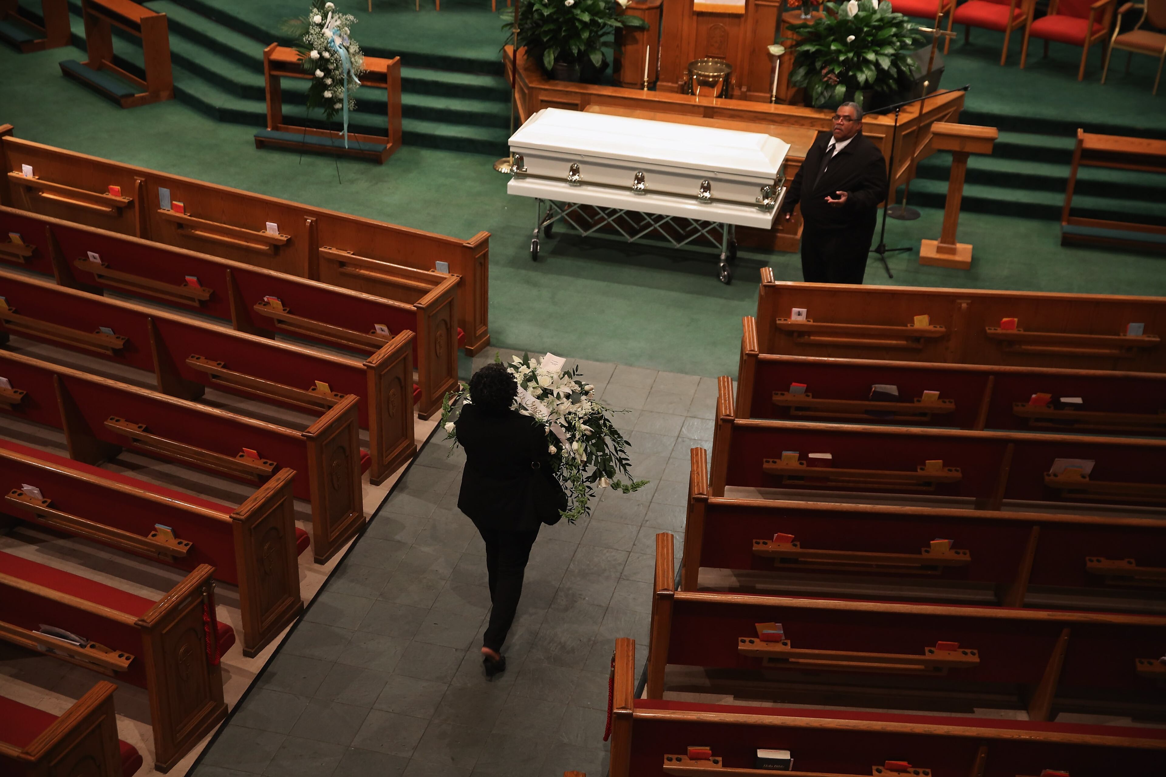 BALTIMORE, MD - APRIL 27: Funeral home employees prepare for Freddie Gray's funeral service inside the New Shiloh Baptist Church during his funeral April 27, 2015 in Baltimore, Maryland. Gray, 25, was arrested for possessing a switch blade knife April 12 outside the Gilmor Homes housing project on Baltimore's west side. According to his attorney, Gray died a week later in the hospital from a severe spinal cord injury he received while in police custody. (Photo by Chip Somodevilla/Getty Images)