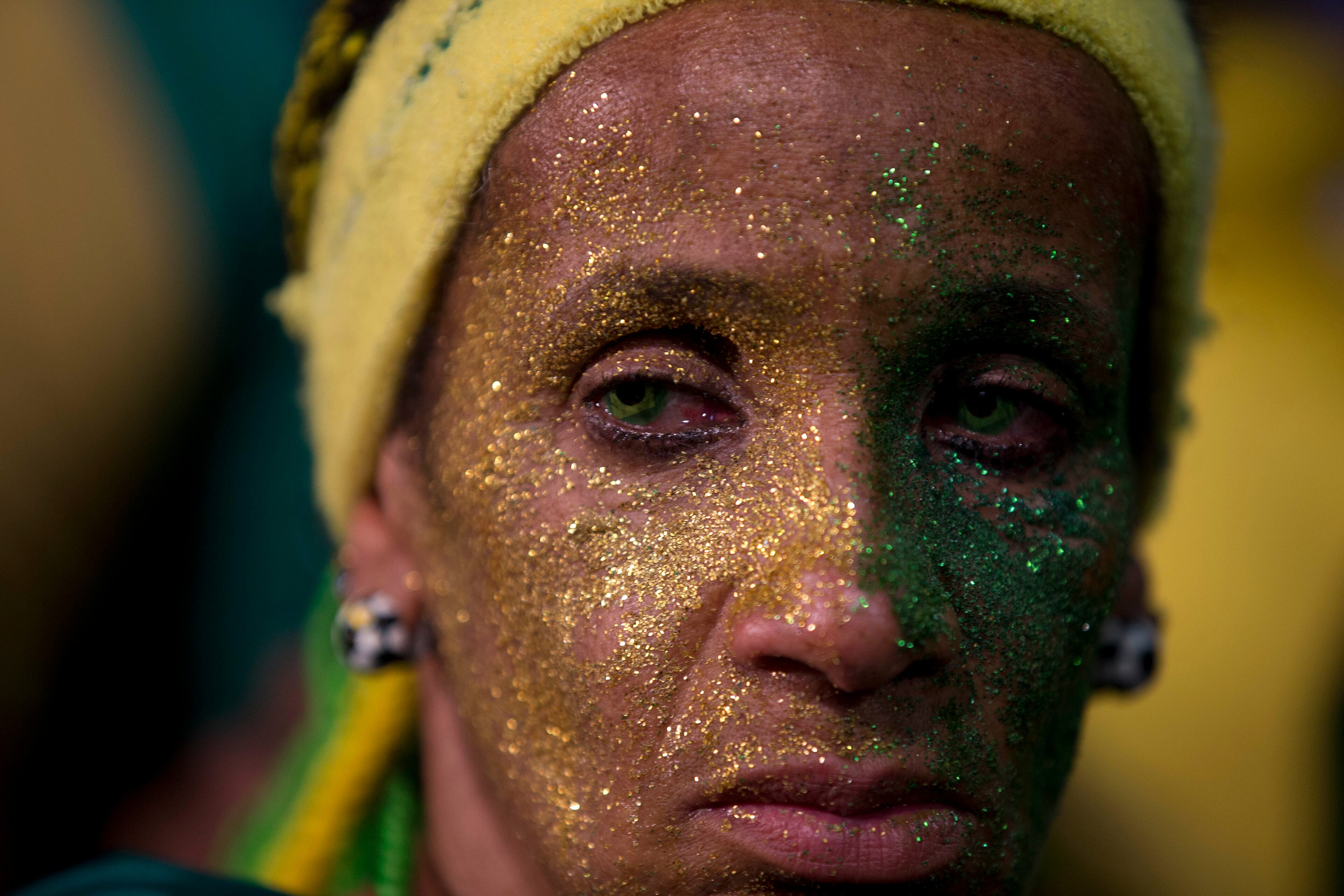 A fan of the Brazilian national soccer team looks on as her team loses to Germany in a semifinal match at the FIFA Fan Fest during the 2014 soccer World Cup, in Sao Paulo, Brazil, Tuesday, July 8, 2014. (AP Photo/Dario Lopez-Mills)