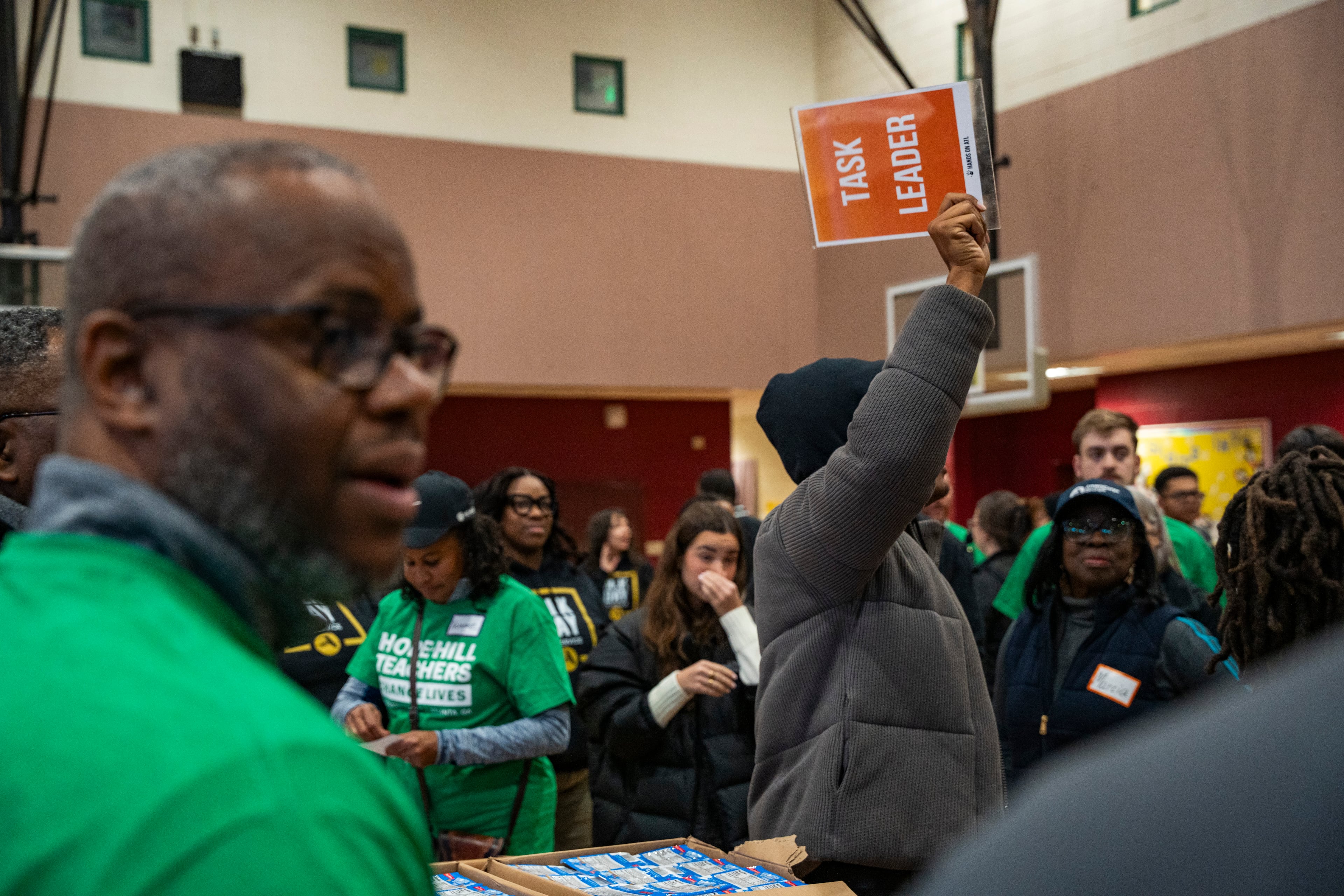 Volunteers from the College Football Playoff Foundation partner with Hands on Atlanta to pack meals and STEAM kits at Hope Hill Elementary in honor of Martin Luther King Jr. Day in Atlanta, Georgia on Monday, Jan. 20, 2025. (Olivia Bowdoin for the AJC).