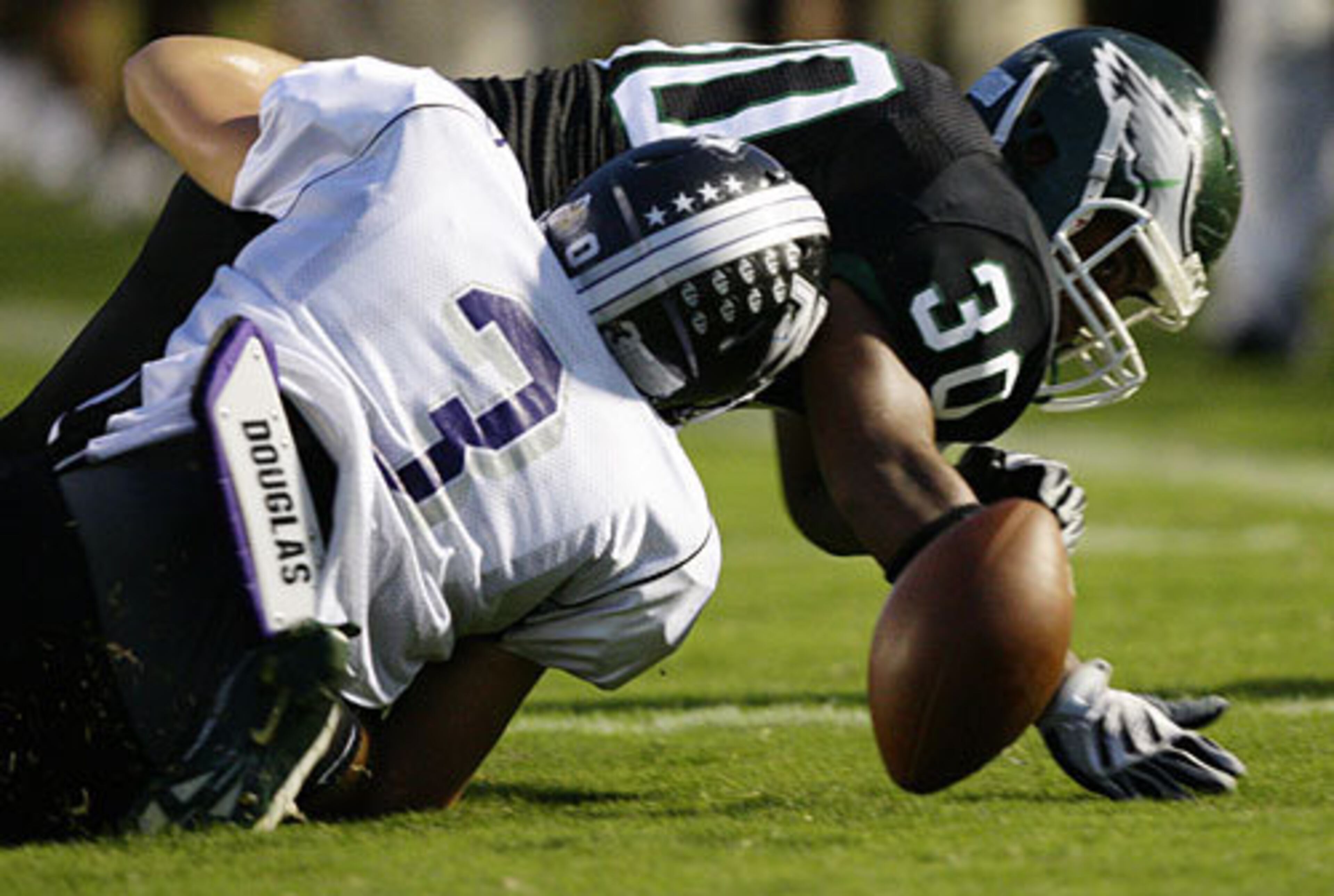 North Forsyth's Quinton Riley (3) tries to block Collins Hill's Travis Parker (30) from recovering a Raiders fumble early in the first quarter.