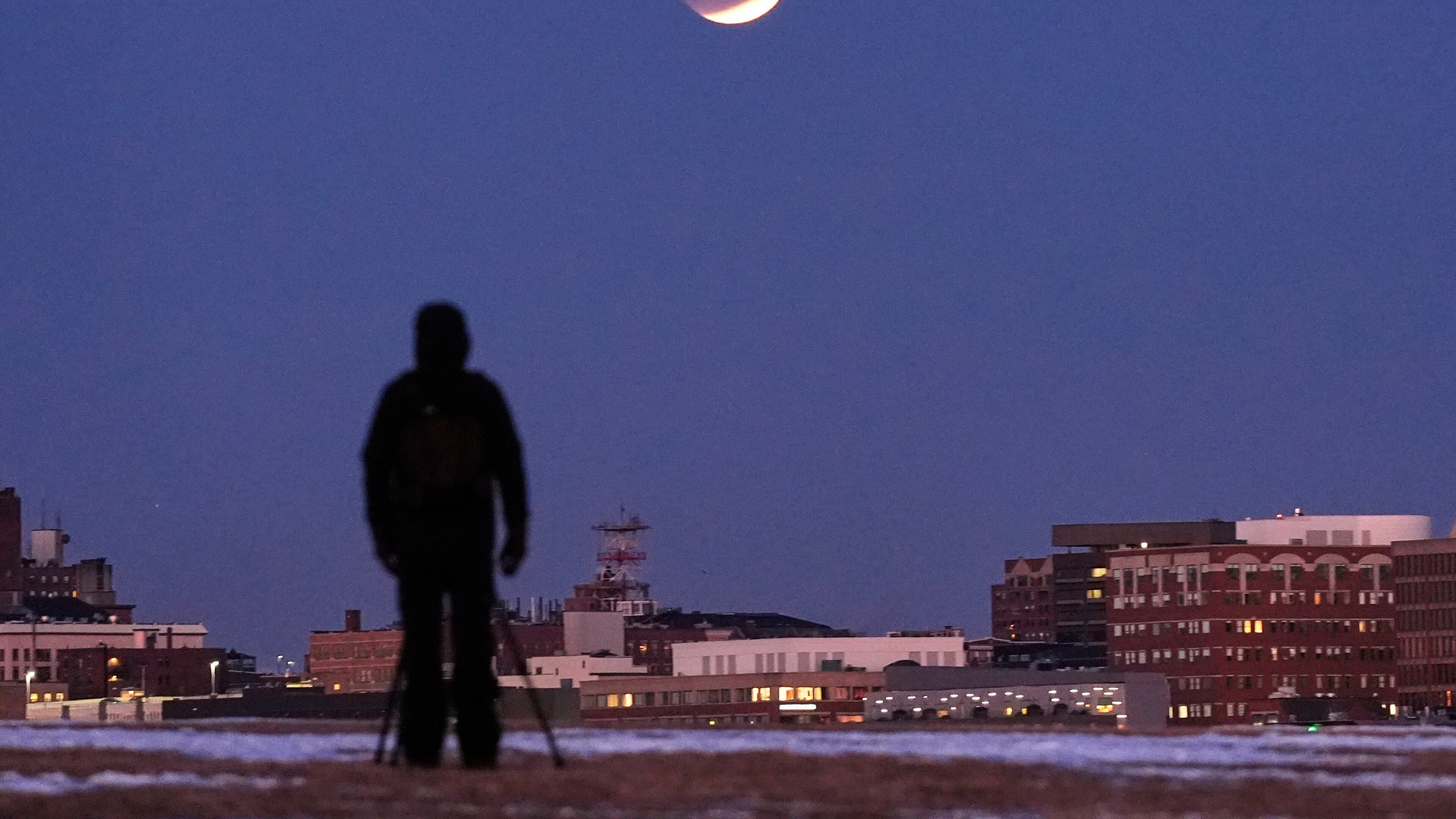 FILE - A man views the lunar eclipse, Tuesday, March 3, 2026, in South Portland, Maine. (AP Photo/Robert F. Bukaty, File)
