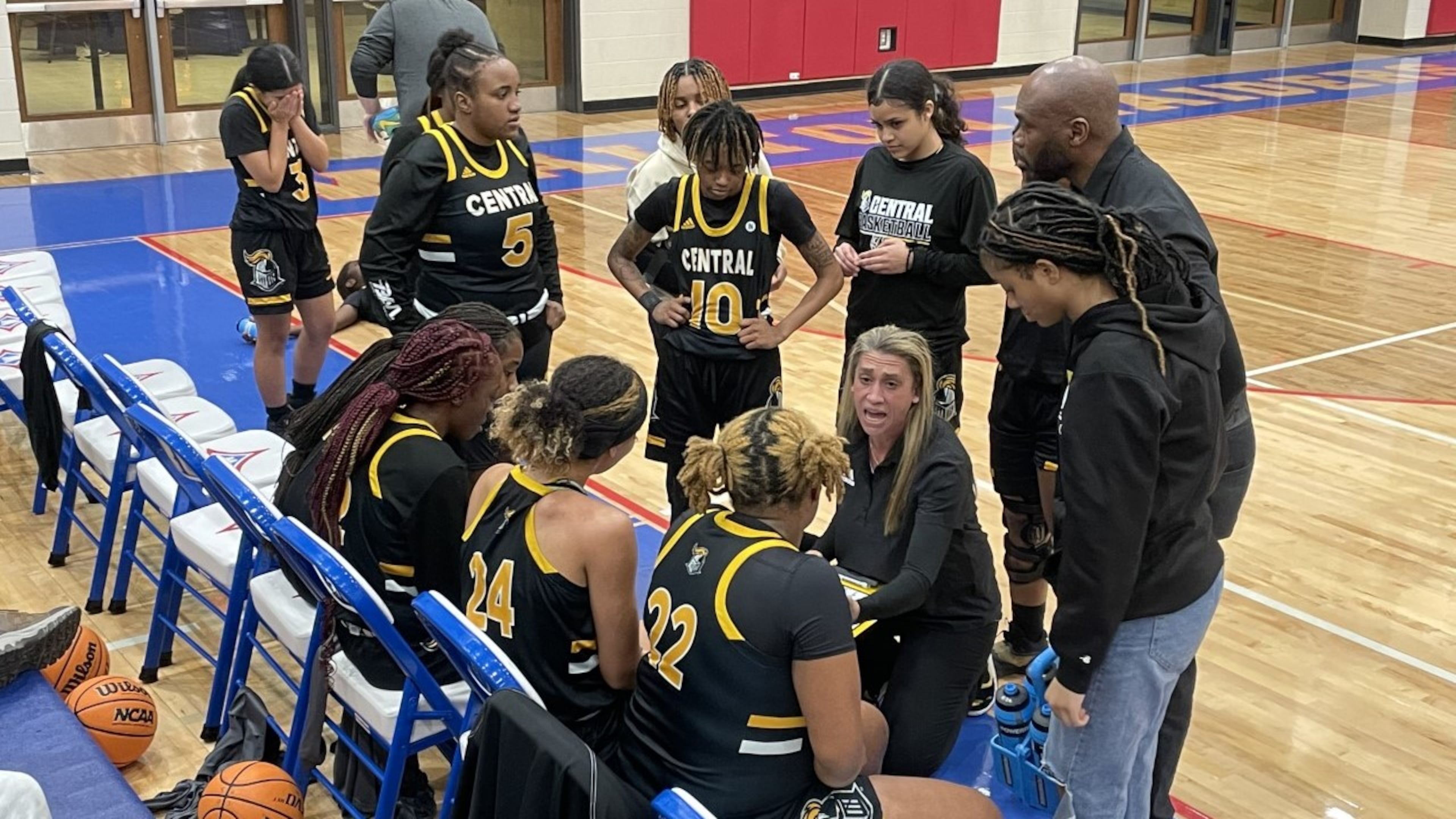 Central Gwinnett coach Courtney Harris talks to her team before the start of the fourth quarter of the Black Knights' 76-48 victory over Walton in the second round of the Class 7A playoffs in Marietta on Feb. 24, 2023.