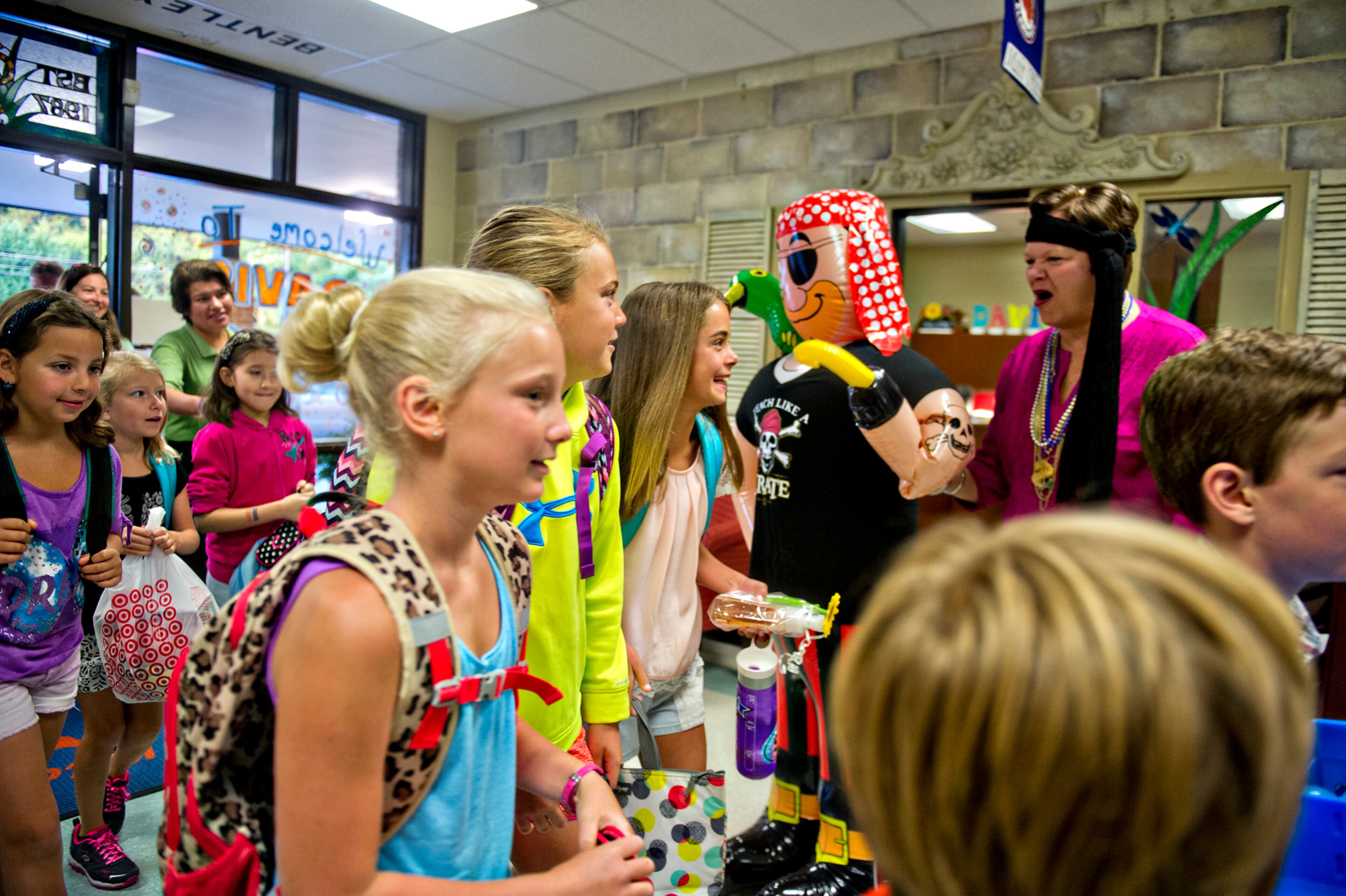 Principal Dr. Dee Mobley (right) greets Maggie Lee, Hampton Gucky, her sister Teller and other students as they pass by during the first day of classes at Davis Elementary School in Marietta on Monday, August 4, 2014. Teachers and administrators at the school dressed as pirates for the first day of school. Students in Cobb County and Atlanta public schools headed back to class on Monday for the new school year. JONATHAN PHILLIPS / SPECIAL