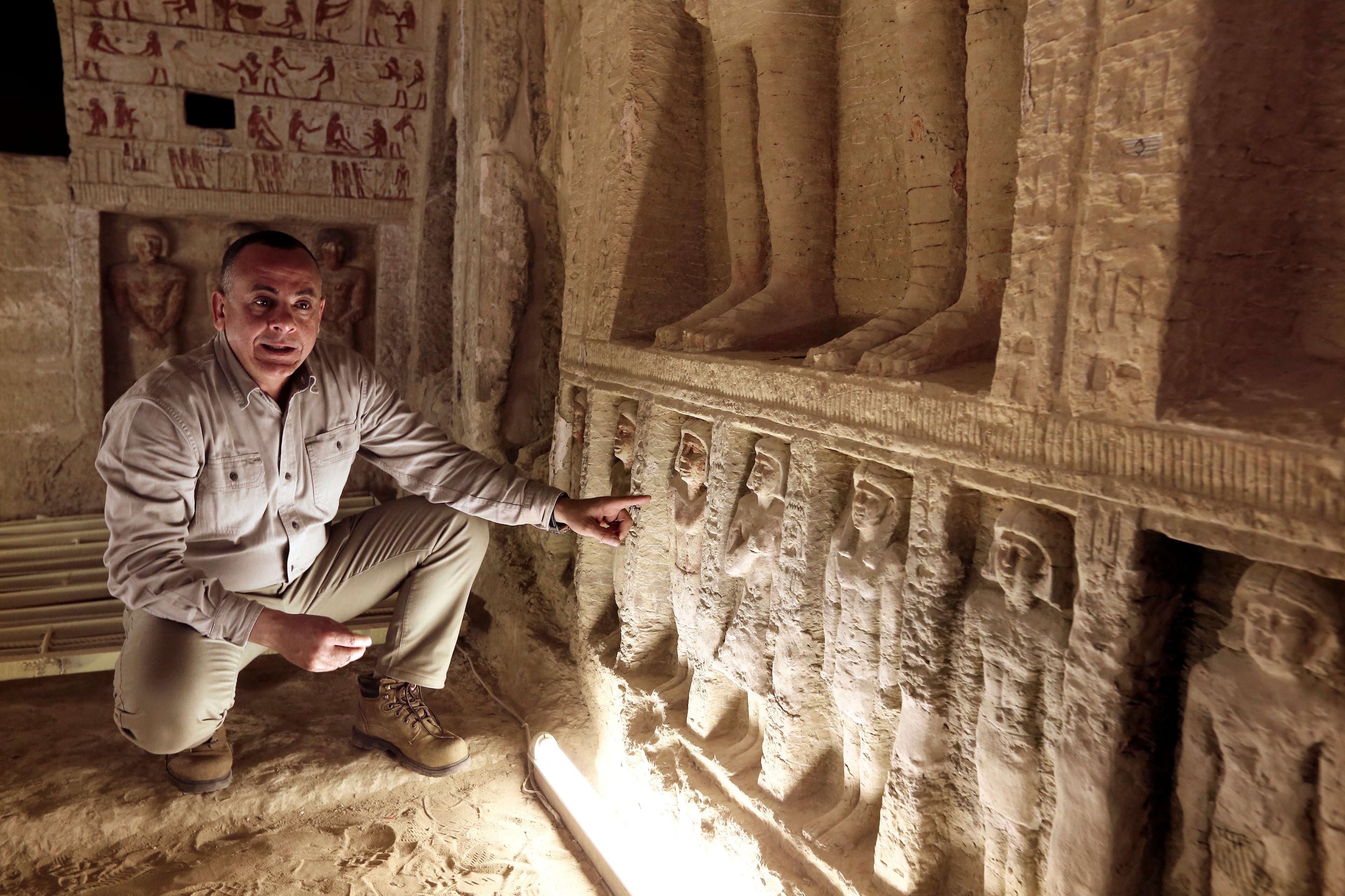 Mostafa Waziri, secretary general of the Supreme Council of Antiquities, speaks inside a recently uncovered tomb of the Priest royal Purification during the reign of King Nefer Ir-Ka-Re, named "Wahtye.", at the site of the step pyramid of Saqqara, in Giza, Egypt, Saturday, Dec. 15, 2018. The Egyptian Archaeological Mission working at the Sacred Animal Necropolis in Saqqara archaeological site succeeded to uncover the tomb, Antiquities Minister Khaled el-Anani, announced. (AP Photo/Amr Nabil)