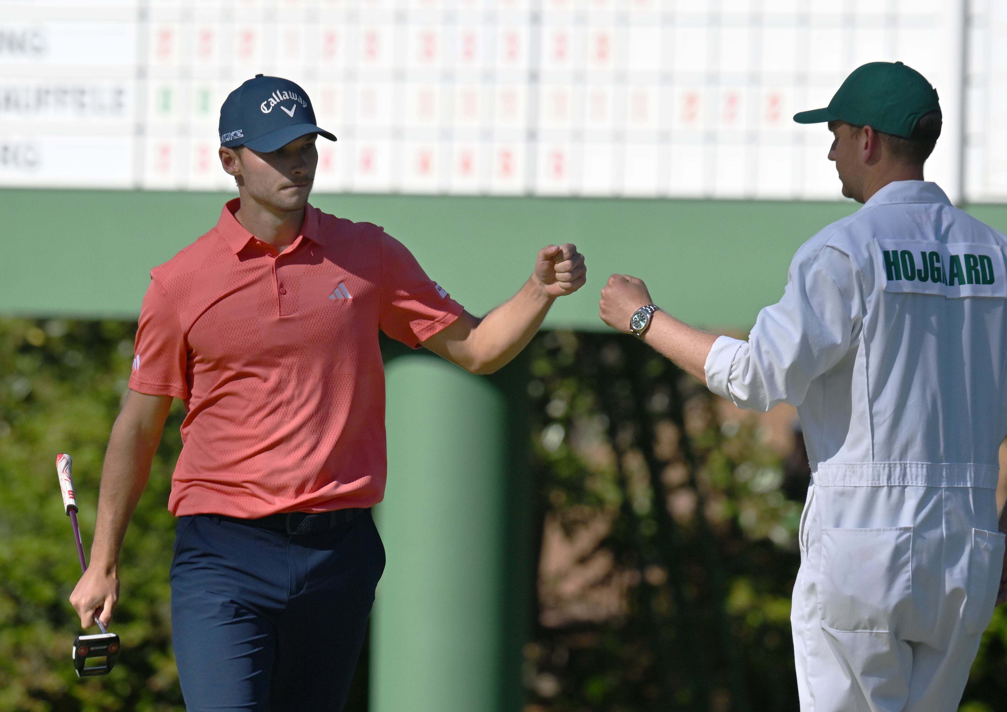 Nicolai Hojgaard and caddie Christian Christensen fist bump after birdie putt on 10th green during third round at the 2024 Masters Tournament at Augusta National Golf Club, Saturday, April 13, 2024, in Augusta, Ga. (Hyosub Shin / Hyosub.Shin@ajc.com)