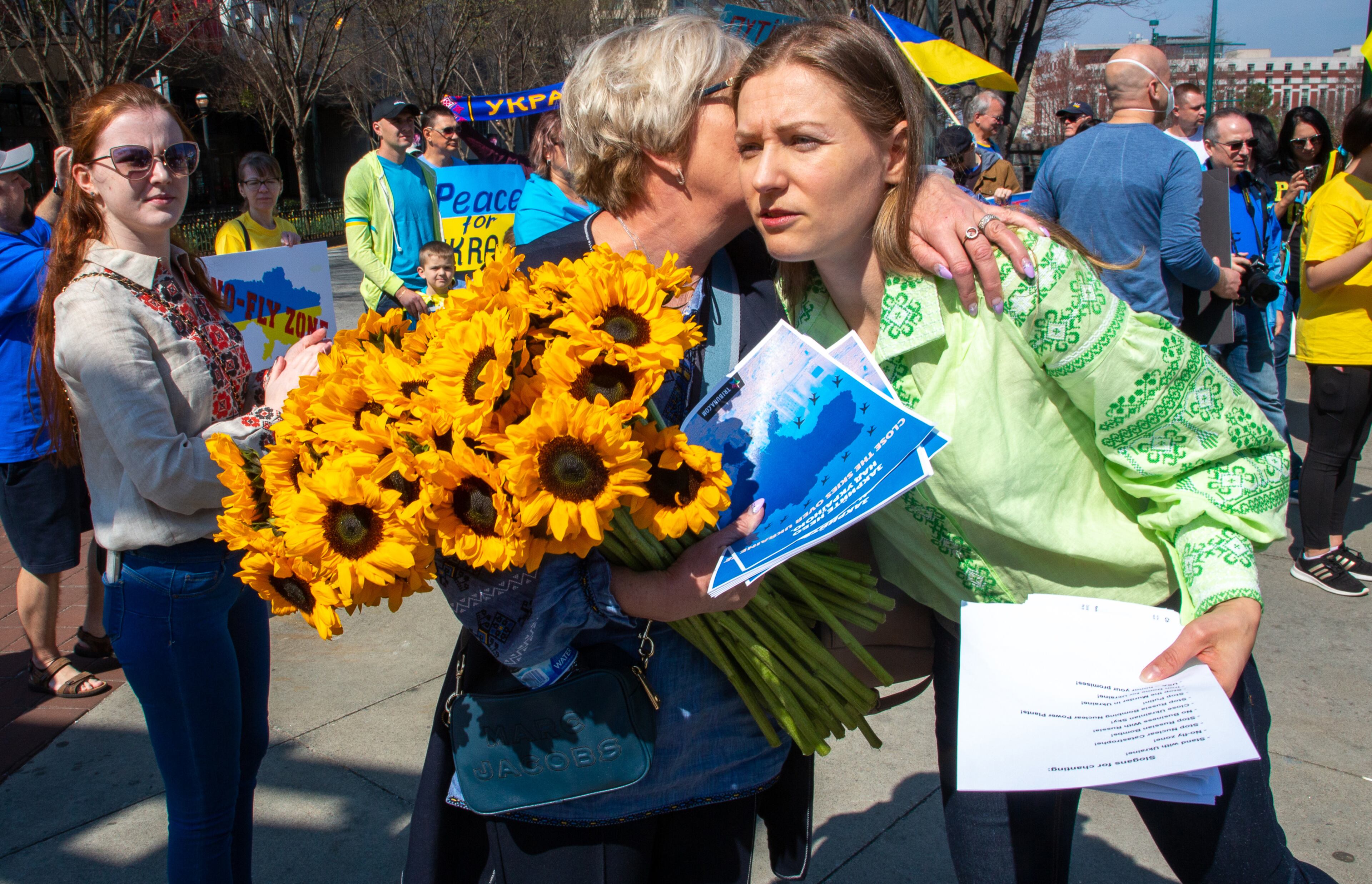 Svitlana Lechtchenko (left) greets Liudmyla Zapukhliak before the start of a rally organized by the Ukrainian Community of Atlanta near the CNN Center and Centennial Olympic Park on Saturday, March 5, 2022. (Photo by Steve Schaefer for The Atlanta Journal-Constitution)