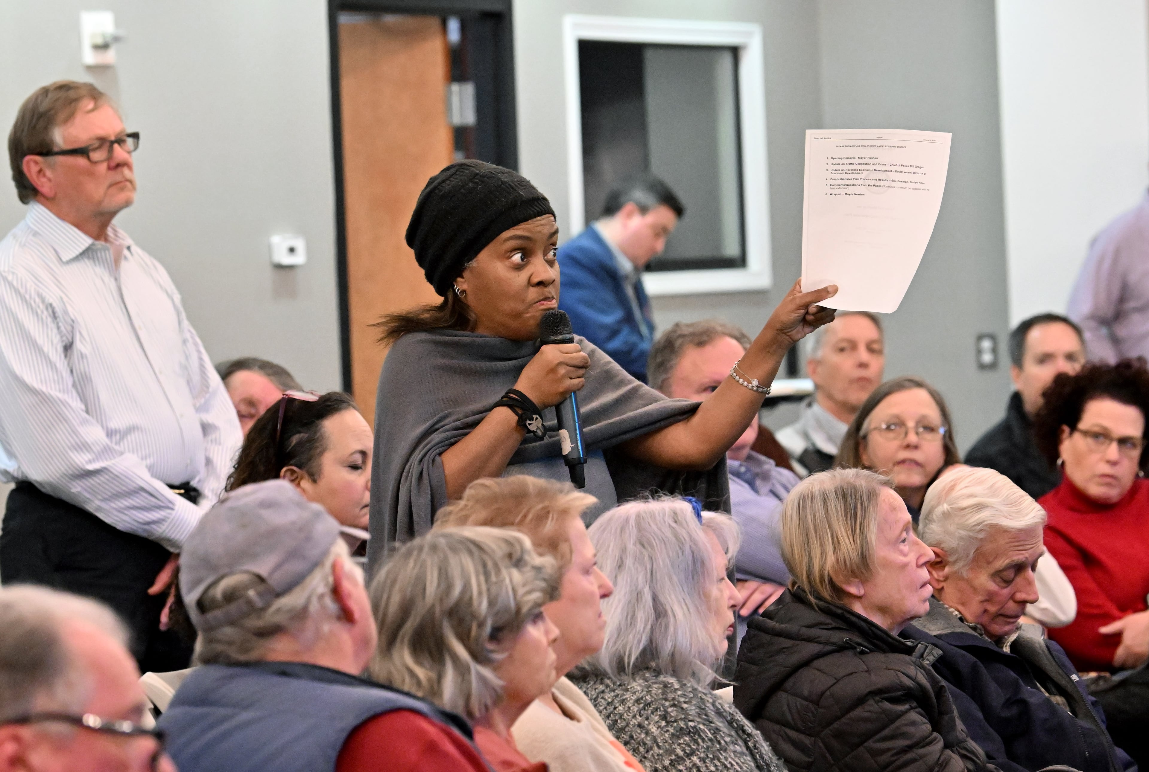 Norcross resident Carrie Tolbert speaks during public comment session at a town hall meeting to discuss proposed changes to the city's comprehensive plan at Norcross Cultural Arts and Community Center, Wednesday, Jan. 28, 2026, in Norcross. The city of Norcross held a town hall to discuss proposed changes to the city's comprehensive plan that residents fear will lead to poorly controlled development of too many apartment buildings. (Hyosub Shin/AJC)