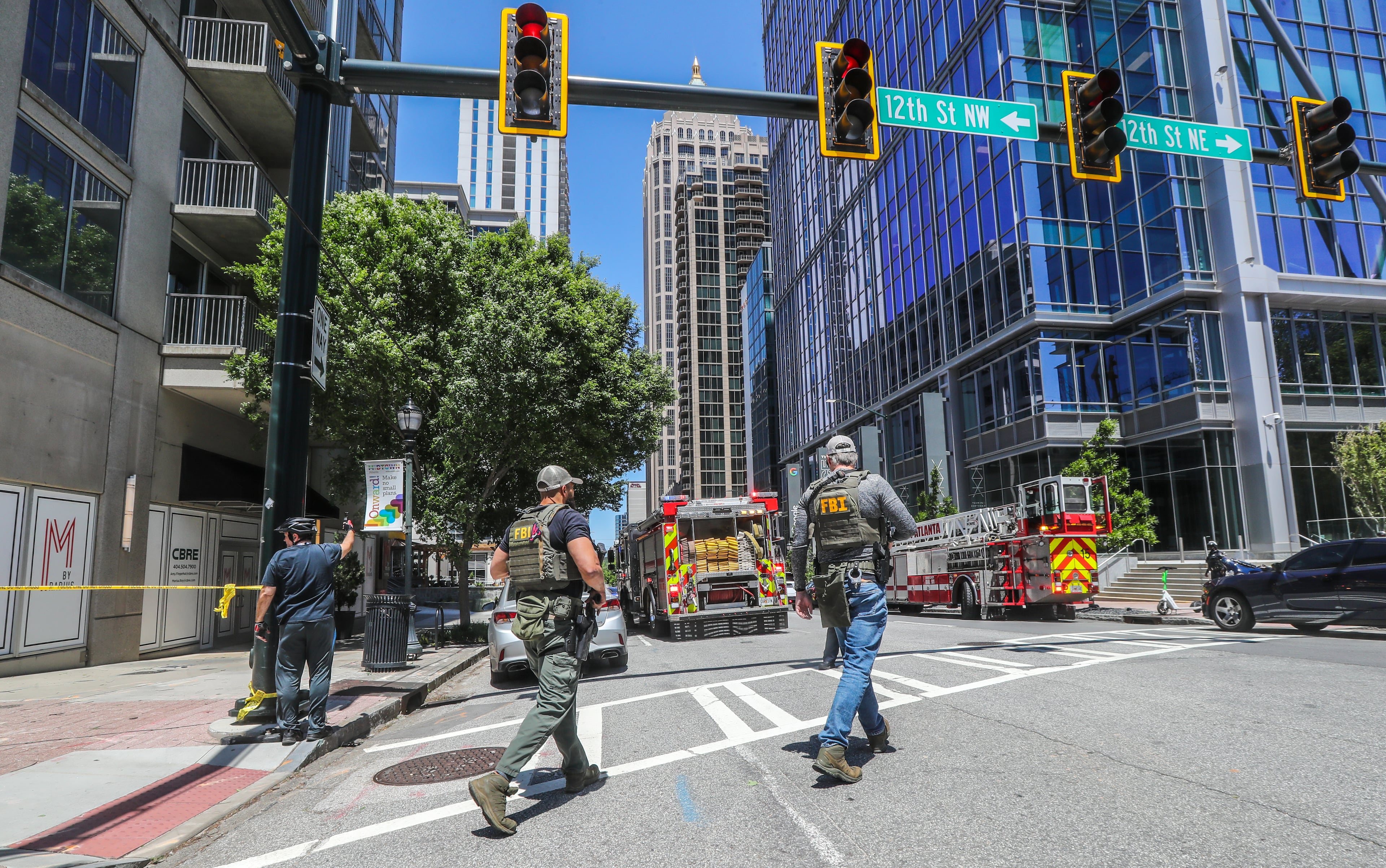 Earlier in the day, Atlanta police and a multijurisdictional police force swarmed the scene of the shooting at 1110 West Peachtree Street. (John Spink / John.Spink@ajc.com)