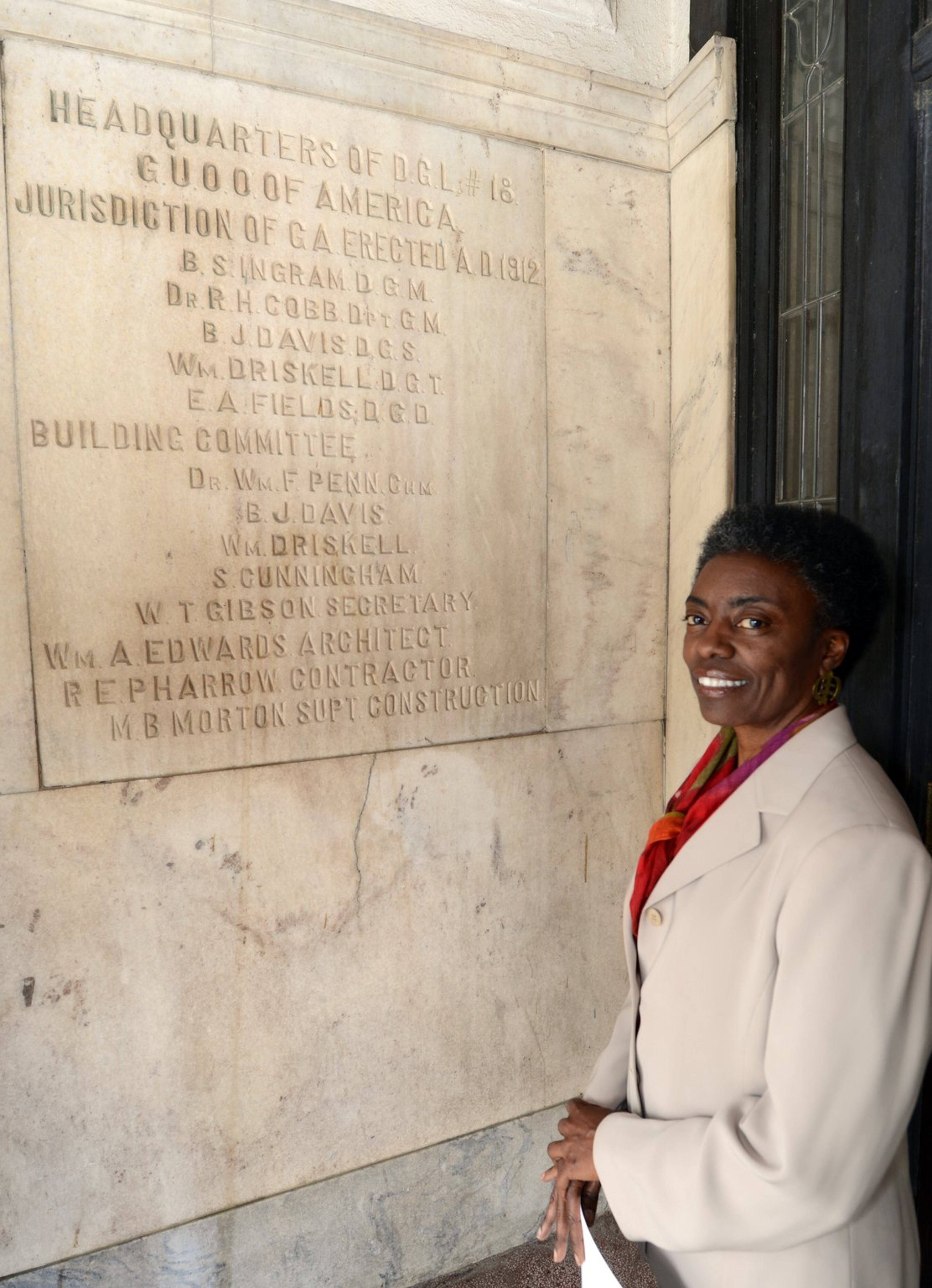 Velma Maia Thomas Fann stands by the cornerstone of the Odd Fellows Building on Auburn Avenue in Atlanta. She went by the building many times before really appreciating its history.