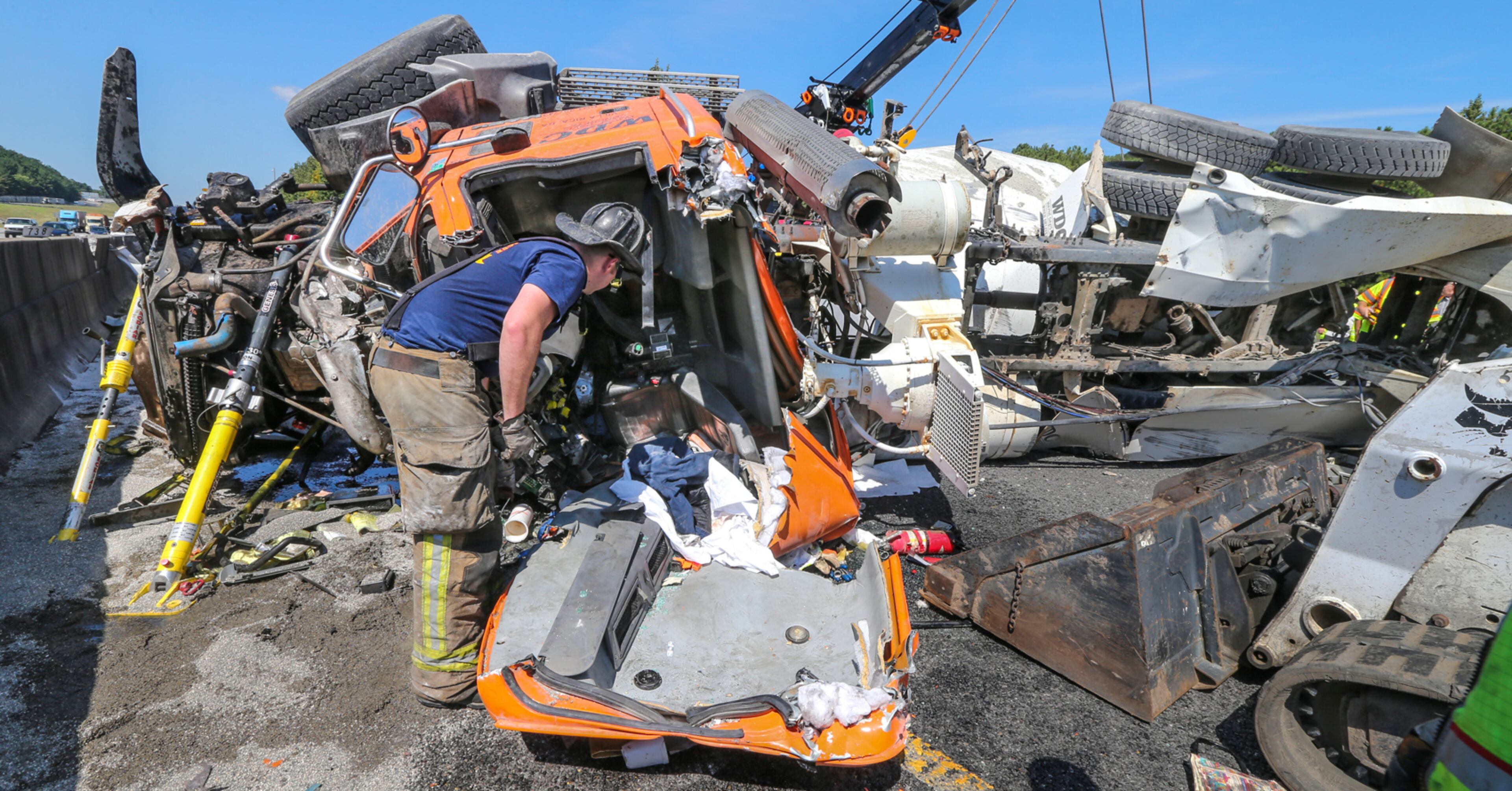 August 23, 2016 DeKalb County: A DeKalb County firefighter examines the empty cab after he and fellow firefighters extricated the driver. Westbound lanes of Interstate 285 reopened Tuesday afternoon, Aug. 23, 2016 after Òa major accidentÓ near Moreland Avenue in DeKalb County, according to the Georgia Department of Transportation. A cement truck blew a tire and lost control overturning into the median wall after 9:30 a.m. DeKalb fire Capt. Eric Jackson said. DeKalb fire Captain Kevin Cavanaugh of Heavy Rescue 24 said the extrication of the driver took a little over an hour during which the driver was talking and alert. He said he had moderate injuries with lacerations on his head and leg and was transported to the hospital. The cleanup operation used several tow trucks before lanes were reopened. JOHN SPINK /JSPINK@AJC.COM