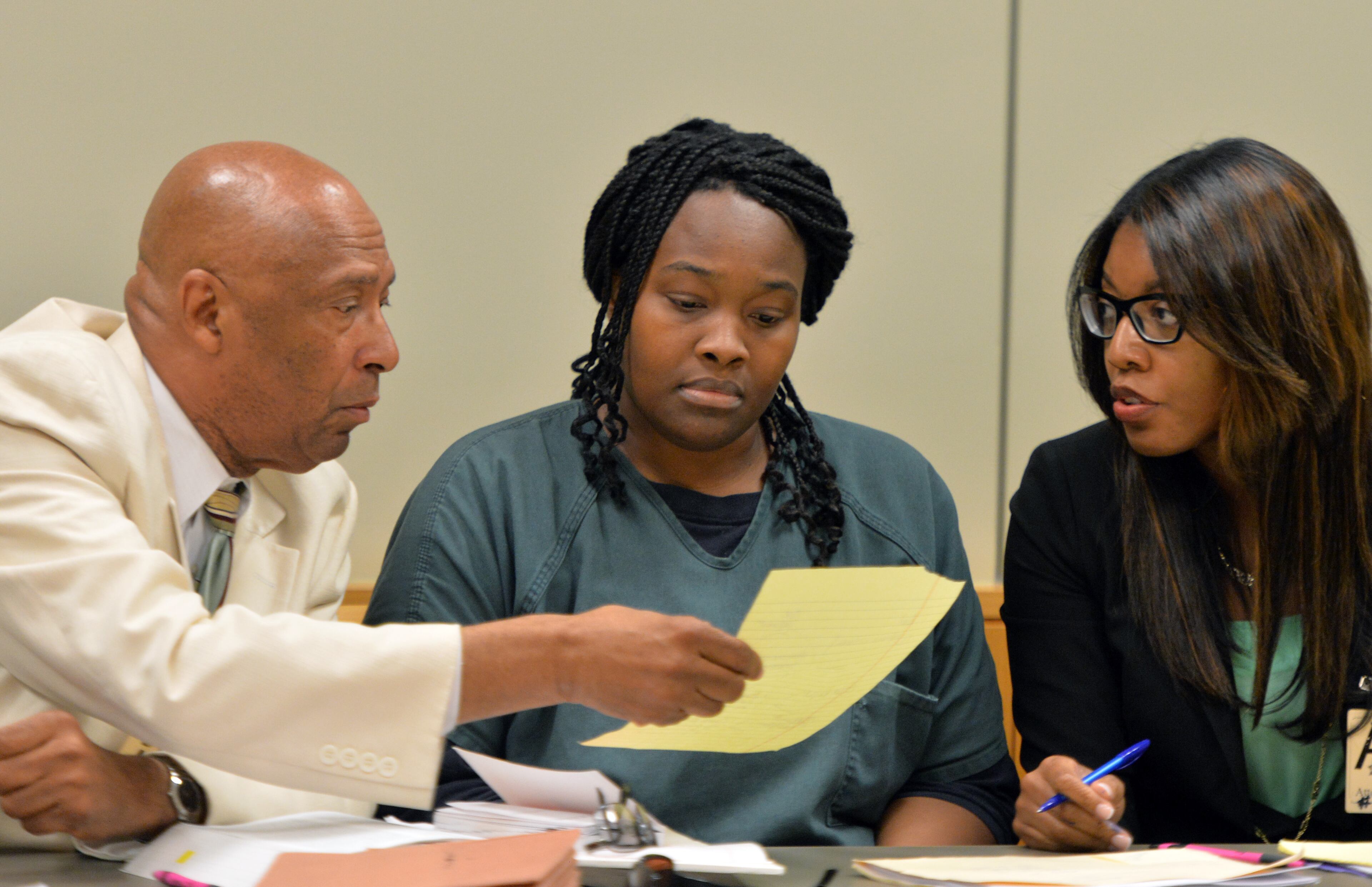 July 10, 2014 Lawrenceville - Therian Wimbushat (cetner) sits with her defense attorneys Dwight Thomas (left) and Otanya Clarke during a hearing before Gwinnett chief magistrate Christina Blum at Gwinnett Magistrate Court in Lawrenceville on Thursday, July 10, 2014. Bond has been denied for Recardo and Therian Wimbush being held on child cruelty charges that they kept their oldest child a prisoner in their home. HYOSUB SHIN / HSHIN@AJC.COM