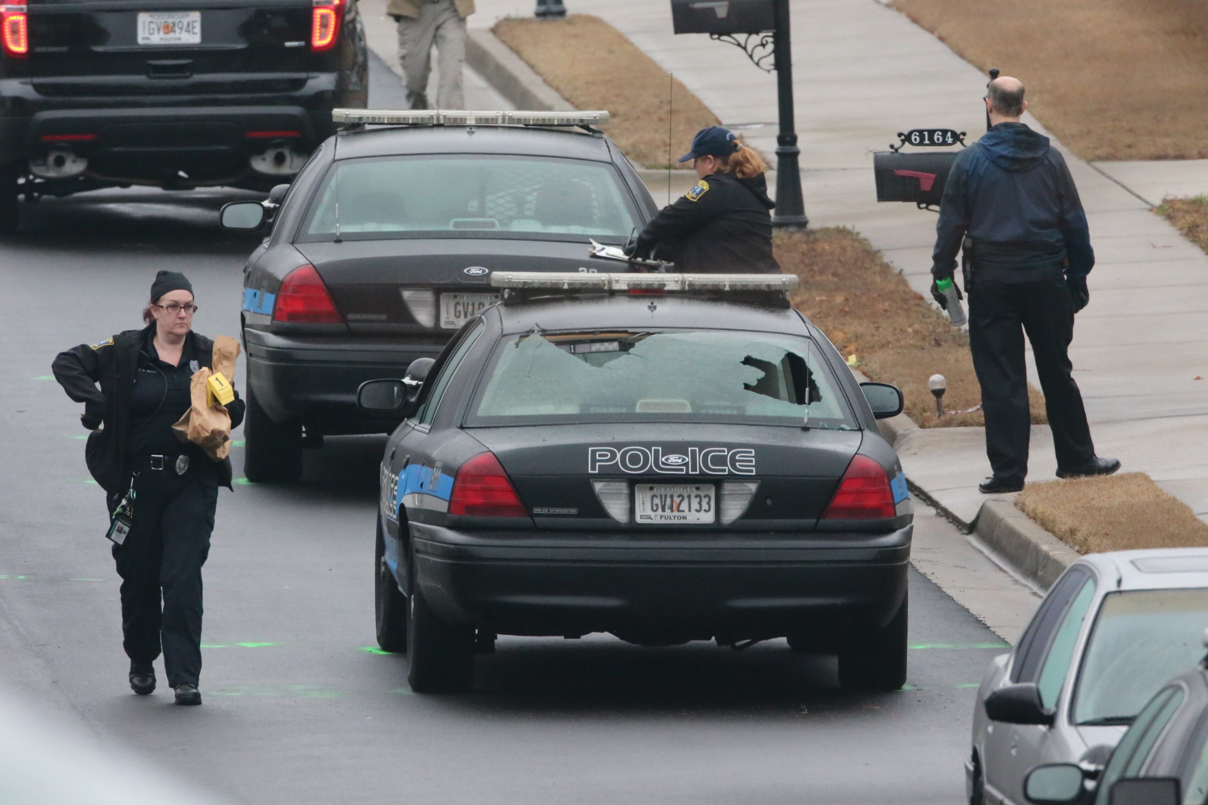 The scene Wednesday morning on Chastain Way in the Parks at Cedar Grove subdivision off Cedar Grove Road after a veteran Fulton County police officer was shot and killed while responding to a call of shots fired near Fairburn.