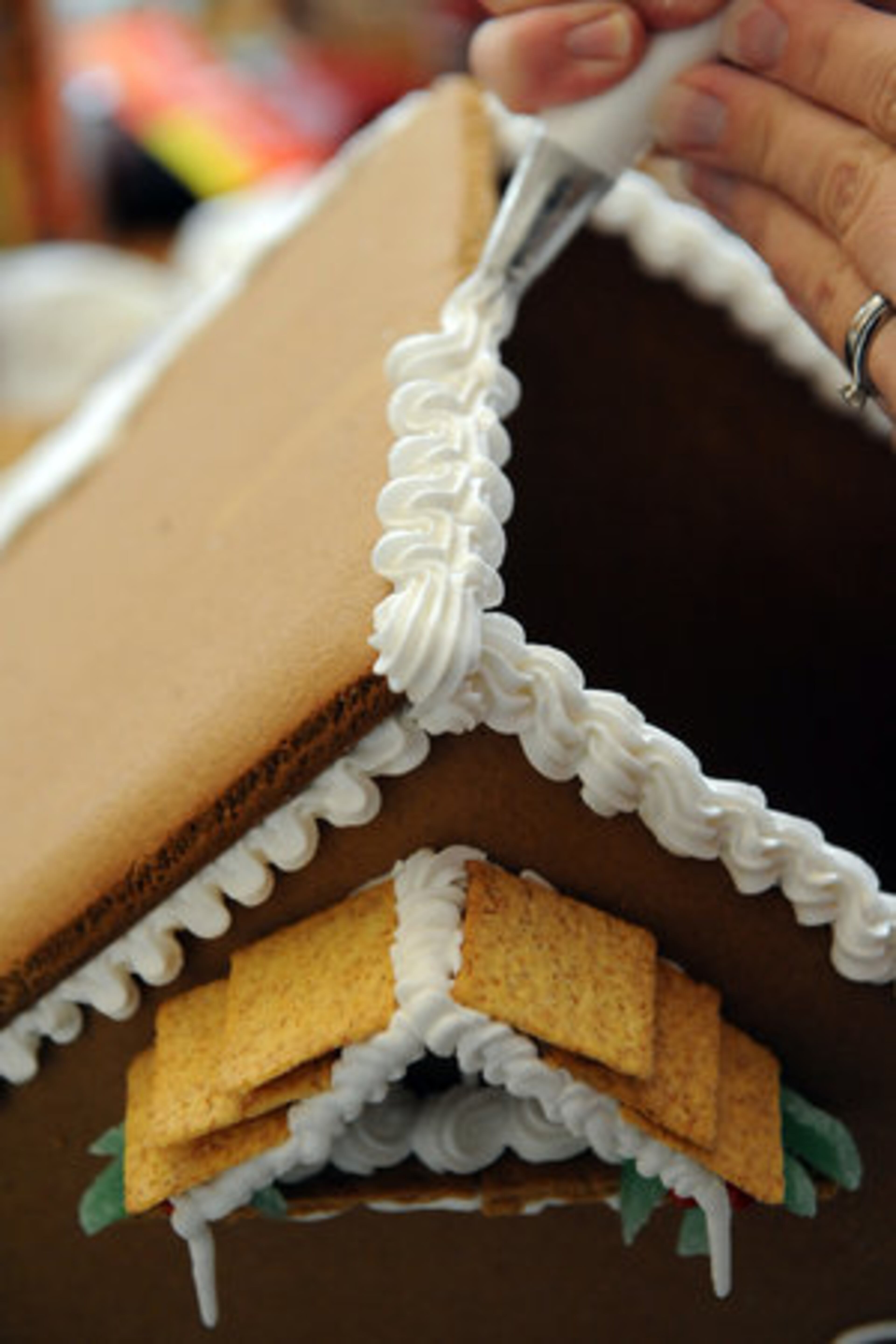 Next, pipe a border down the center of the roof. HYOSUB SHIN / HSHIN@AJC.COM