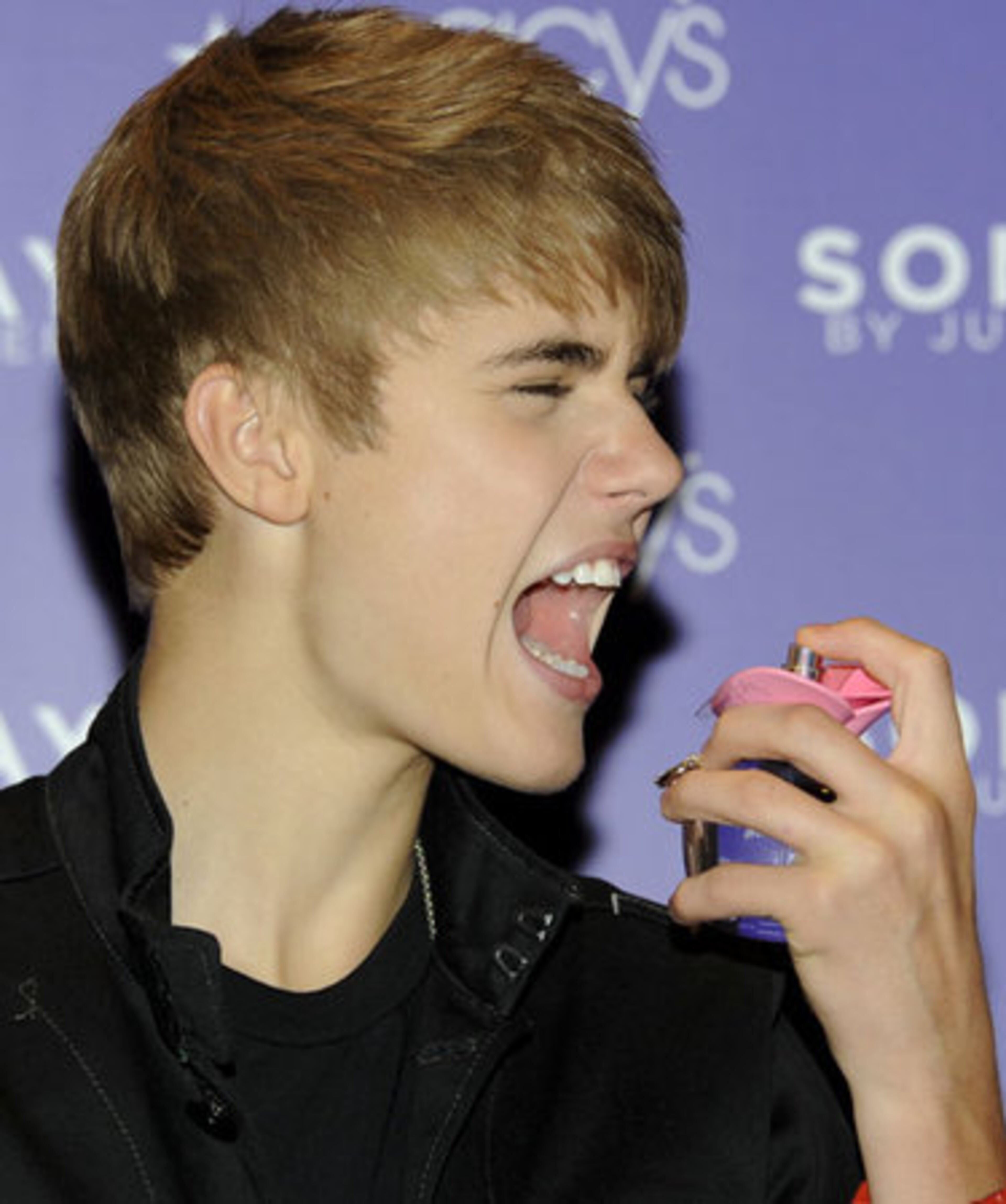 Bieber pretends to use the bottle of Someday as breath spray because, really, how many interesting things can you do with a bottle of perfume while you awkwardly pose for photographers?