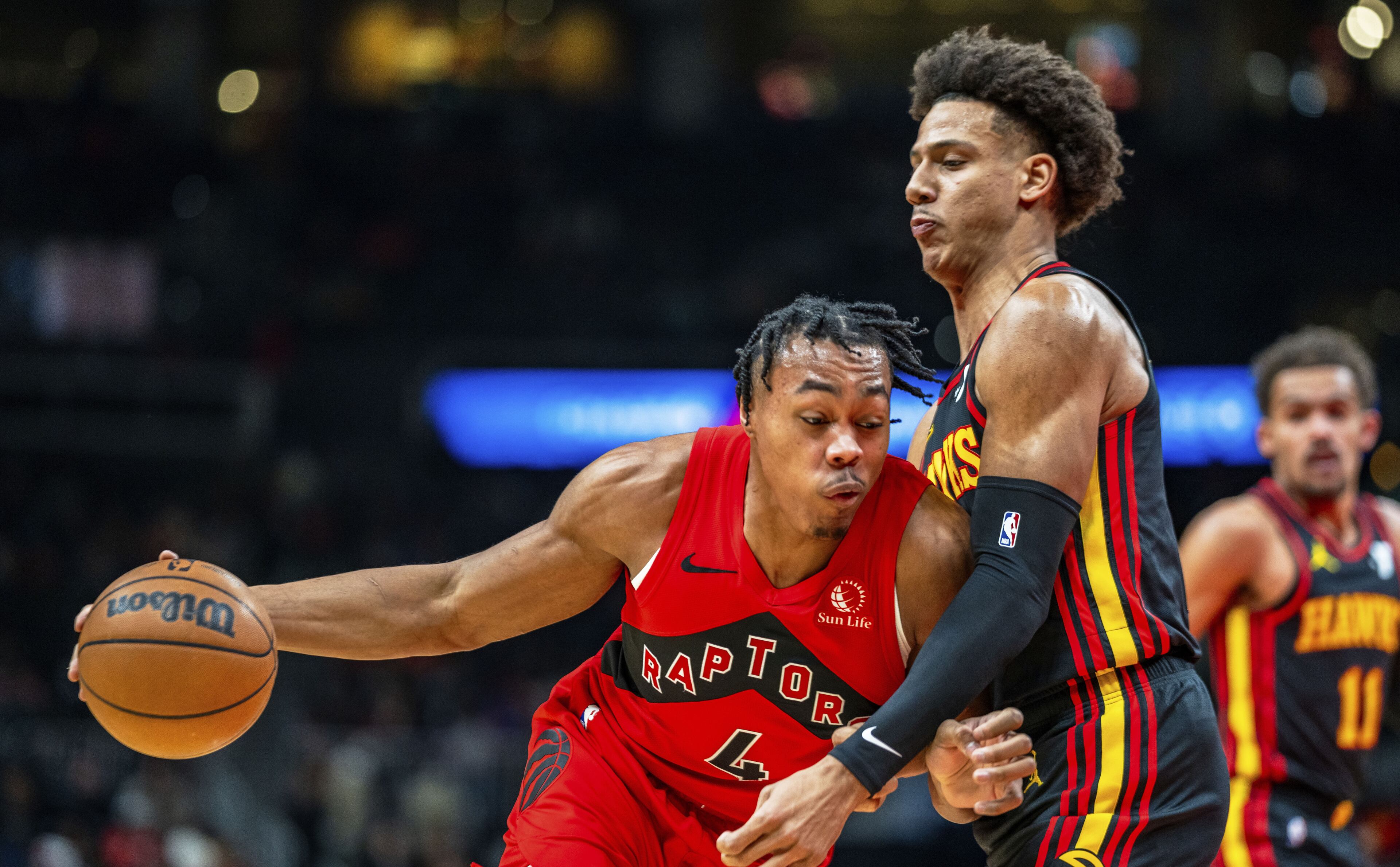 Hawks forward Jalen Johnson defends against the drive of Toronto's Scottie Barnes during Friday's game at State Farm Arena. The Raptors defeated the Hawks 123-121.