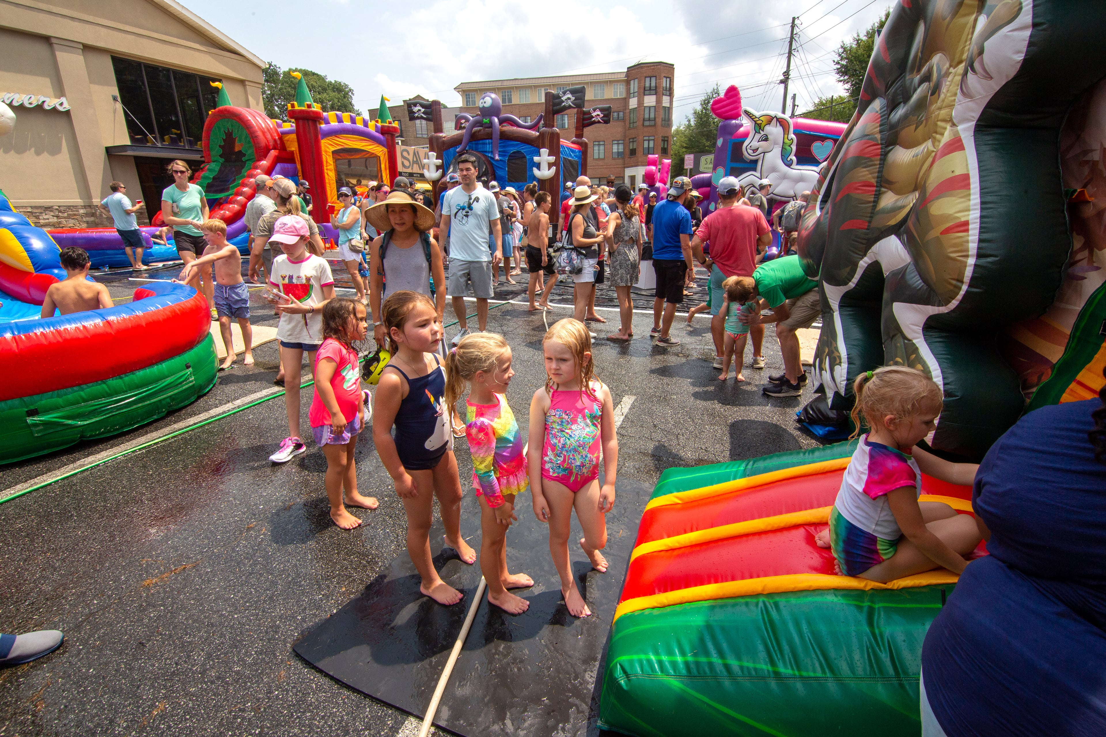 Kids line up to enter one of the Inflatable Bounce Houses during the Brookhaven Cherry Blossom Festival on Saturday, July 31, 2021. STEVE SCHAEFER FOR THE ATLANTA JOURNAL-CONSTITUTION