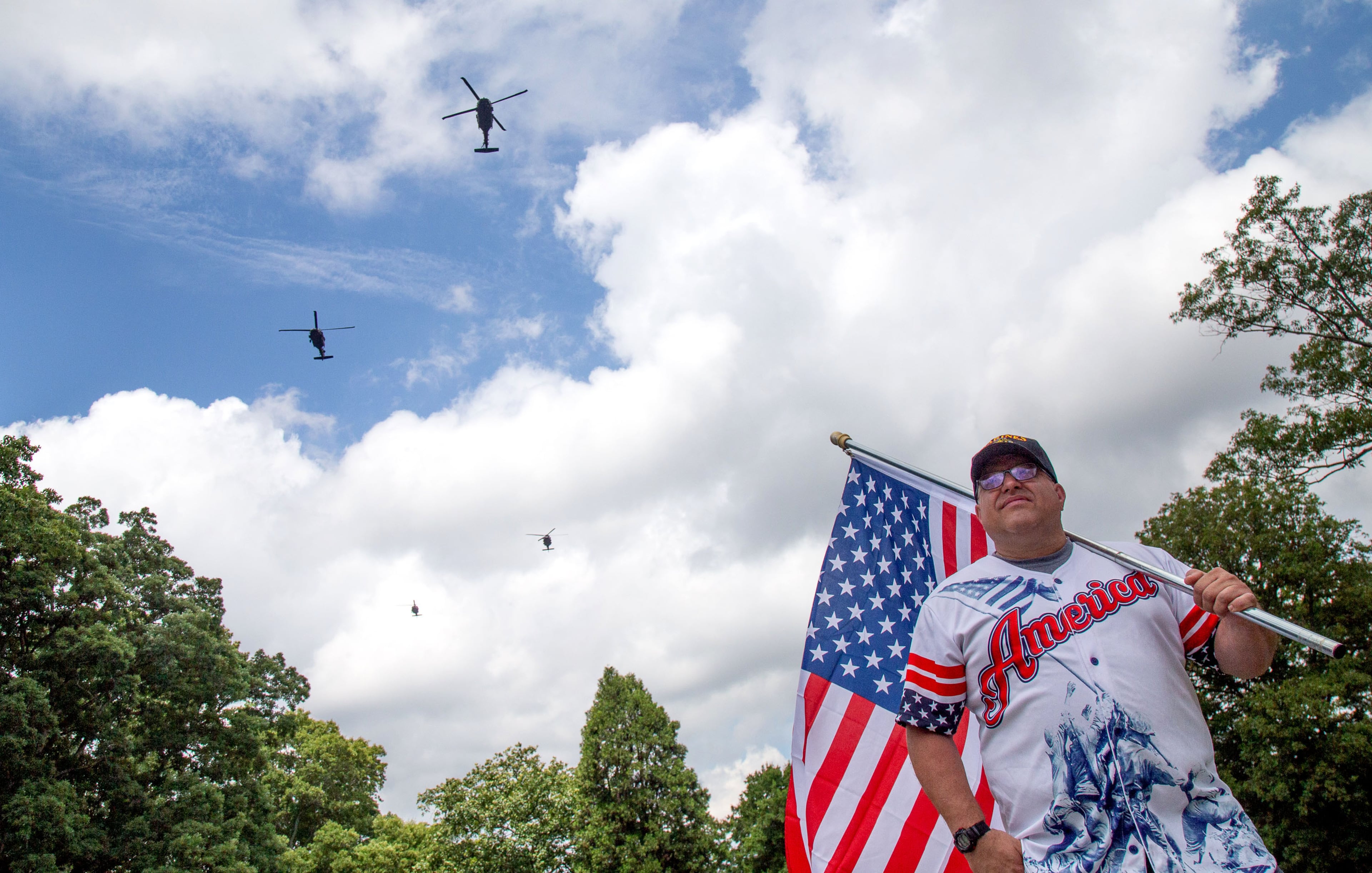 Ricca Mason watches the GA National Guard Blackhawks that flew over the Marietta National Cemetery Monday, May 25, 2020. STEVE SCHAEFER FOR THE ATLANTA JOURNAL-CONSTITUTION