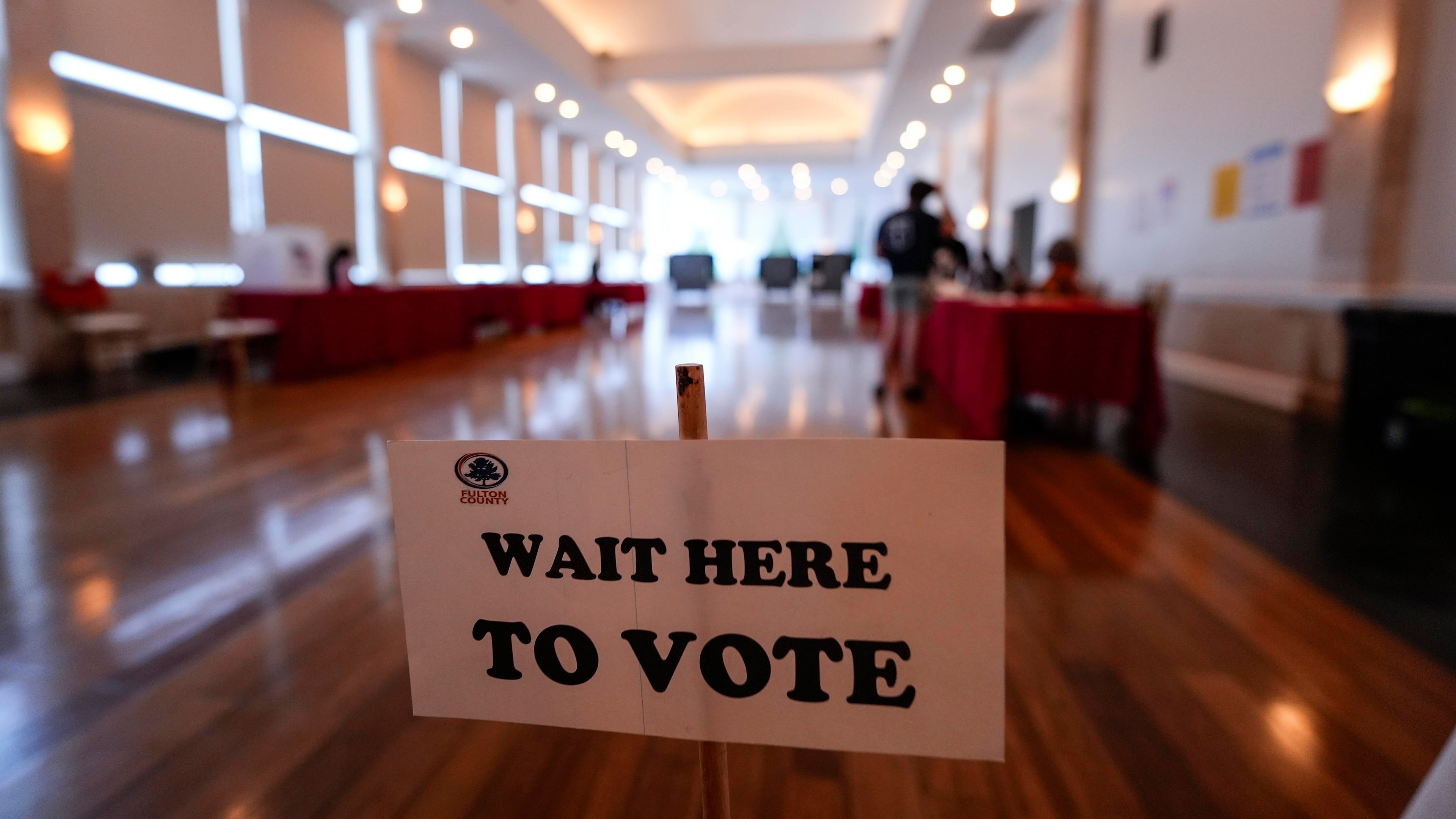 People vote in a runoff election at Park Tavern, Tuesday, June 16, 2026, in Atlanta. (AP Photo/Mike Stewart)